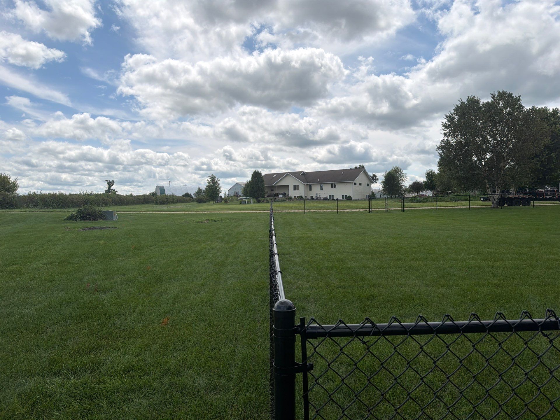 Black Vinyl-Coated Chain Link Fence Installation in Fairbank by Perfect Picket Fence and Stain