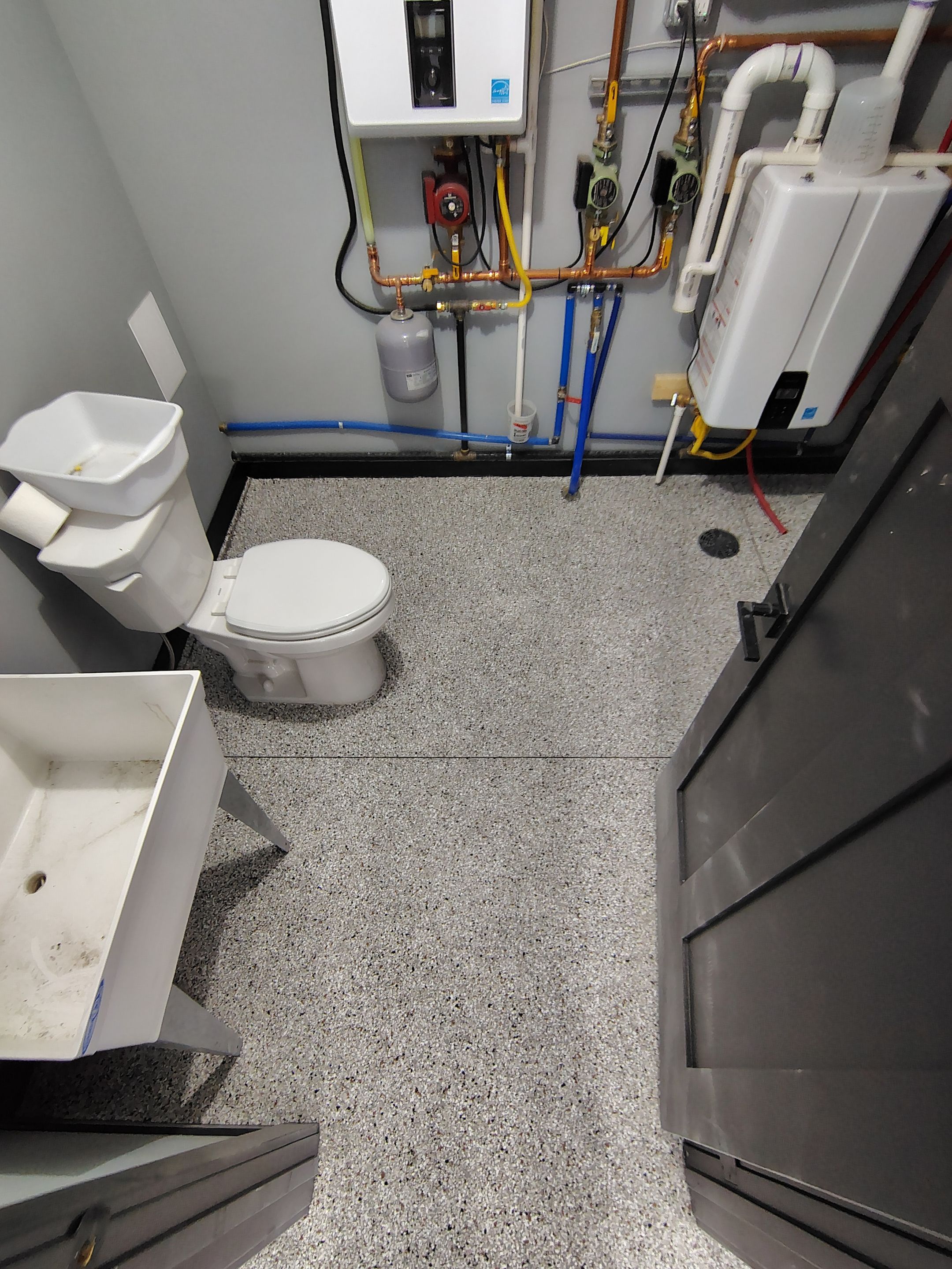 Polyaspartic Garage Floor Coating with Decorative Flake in Wentworth by Select Painting, Coatings & Garage Cabinets