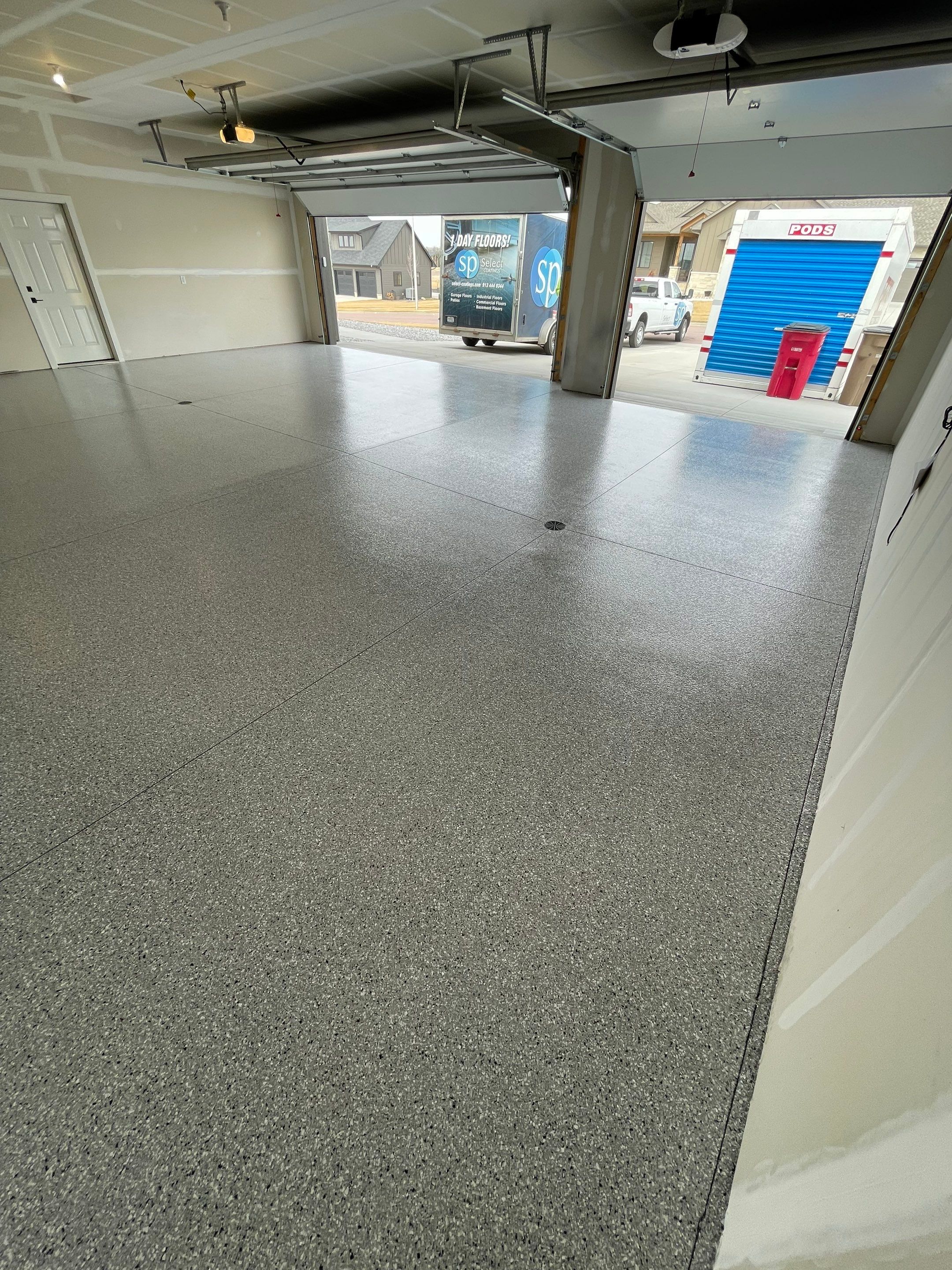 Grey Speckled Epoxy Floor Coating for Sioux Falls Garage by Select Painting, Coatings & Garage Cabinets