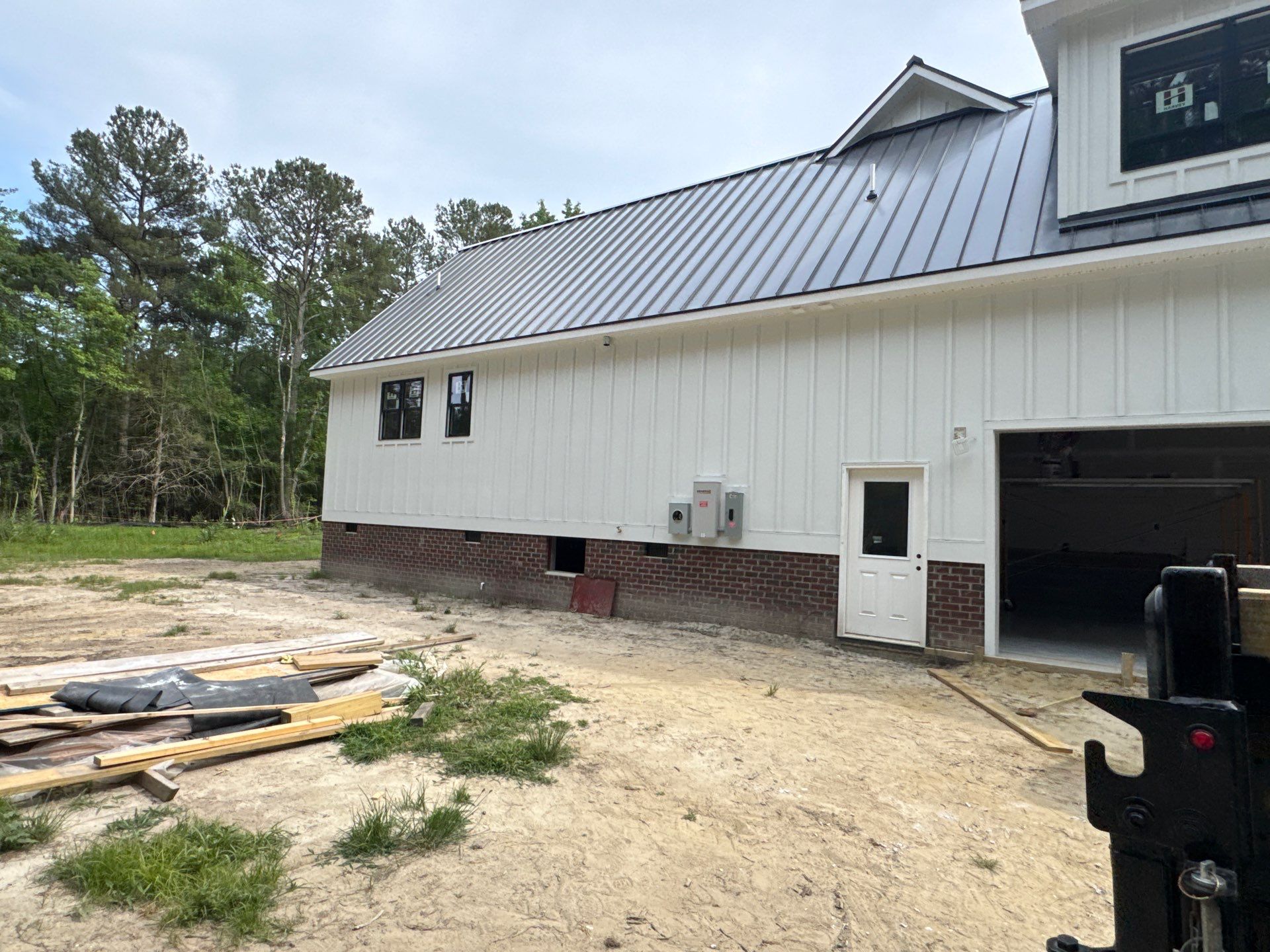 Custom New Construction Home Featuring Standing Seam Metal Roofing in Port Haywood by Cade Construction
