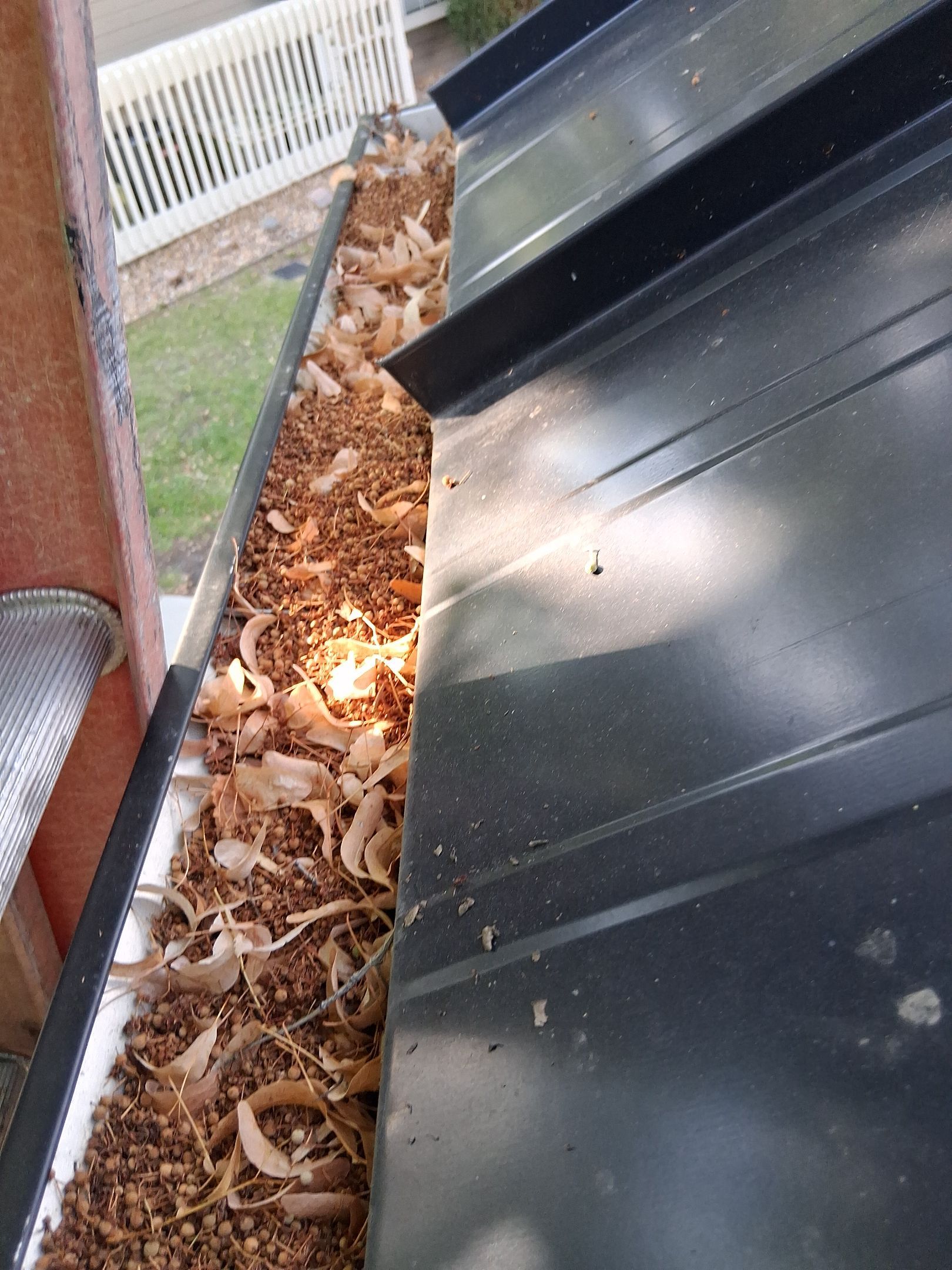 Commercial gutter cleaning Denver, CO before photo with filled gutters