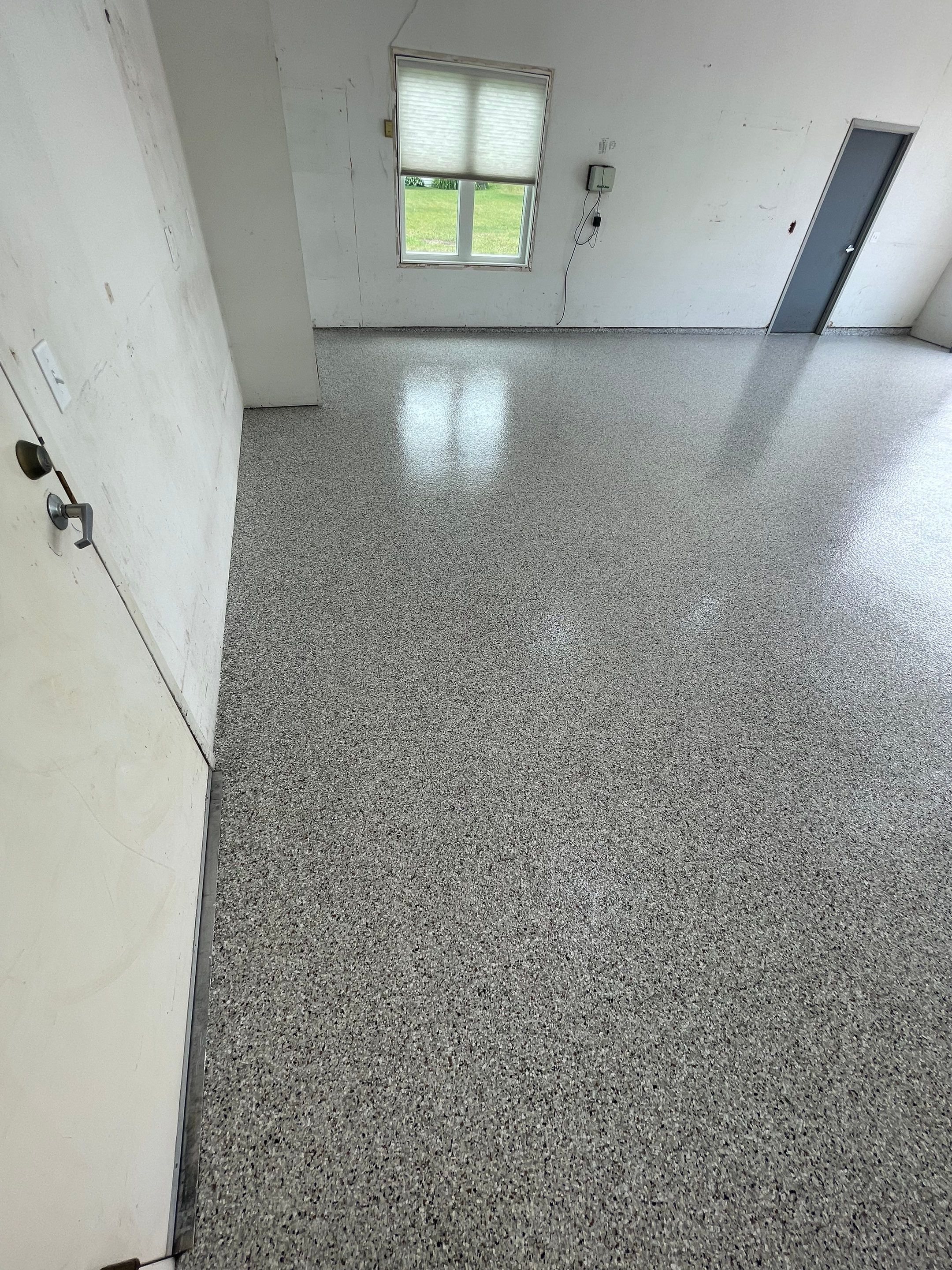 Coyote Flake Concrete Coating for Sioux Falls Garage by Select Painting, Coatings & Garage Cabinets