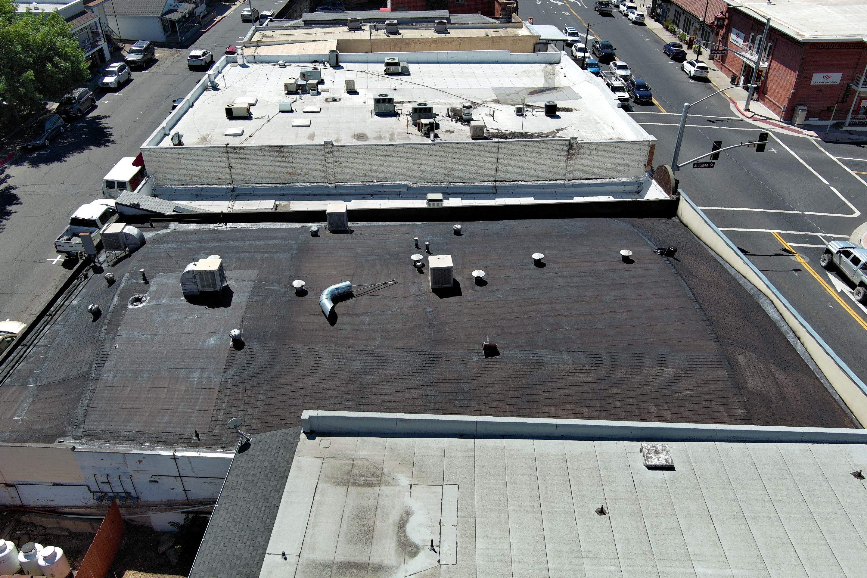 Foam and coatings on commercial roof by Straight Edge Roofing Inc