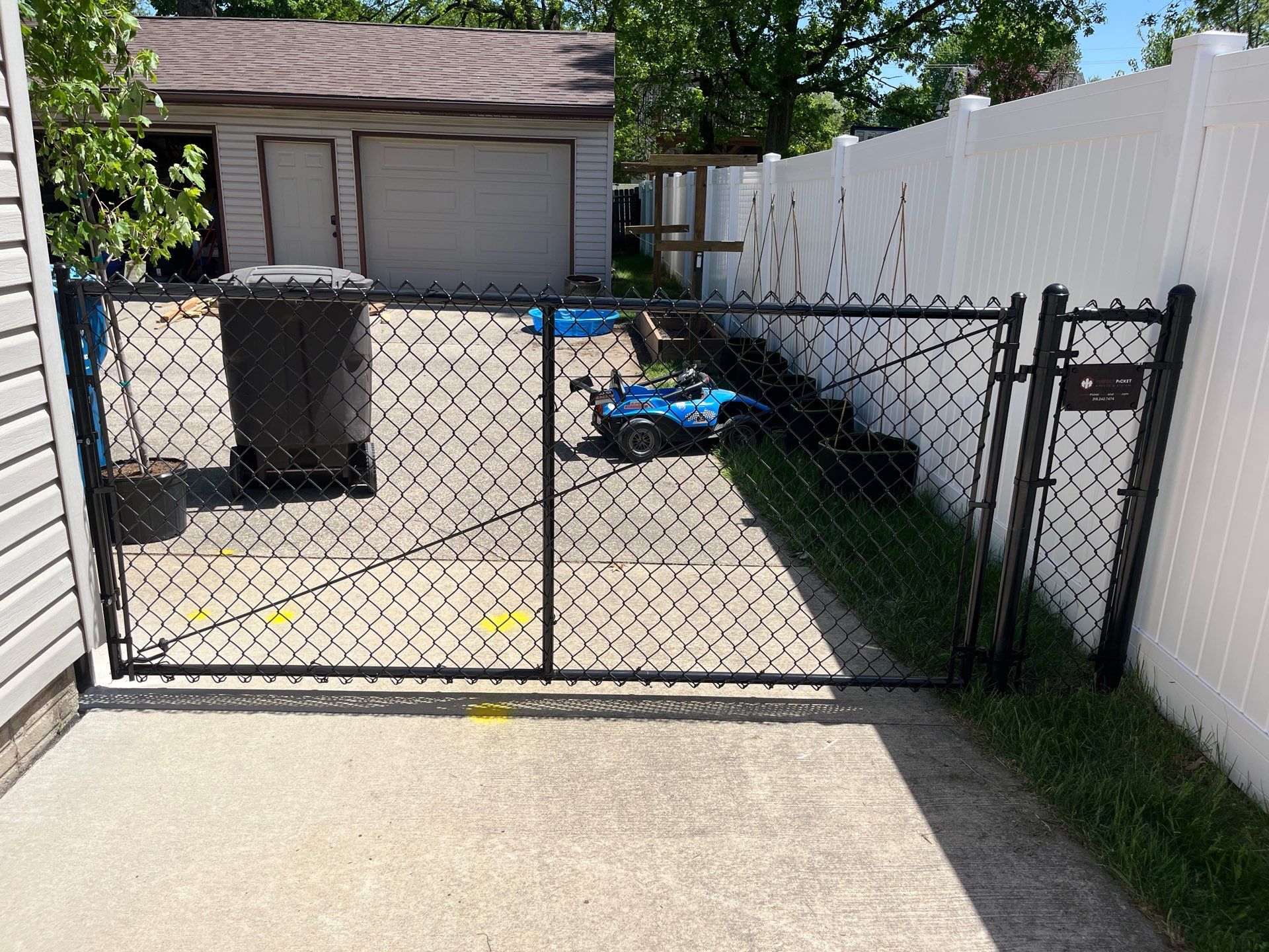 Black Chain Link Fence and Driveway Gate Installation in Waterloo by Perfect Picket Fence and Stain