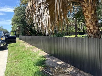 Bronze Scalloped Metal Privacy Fence Installation in North Port