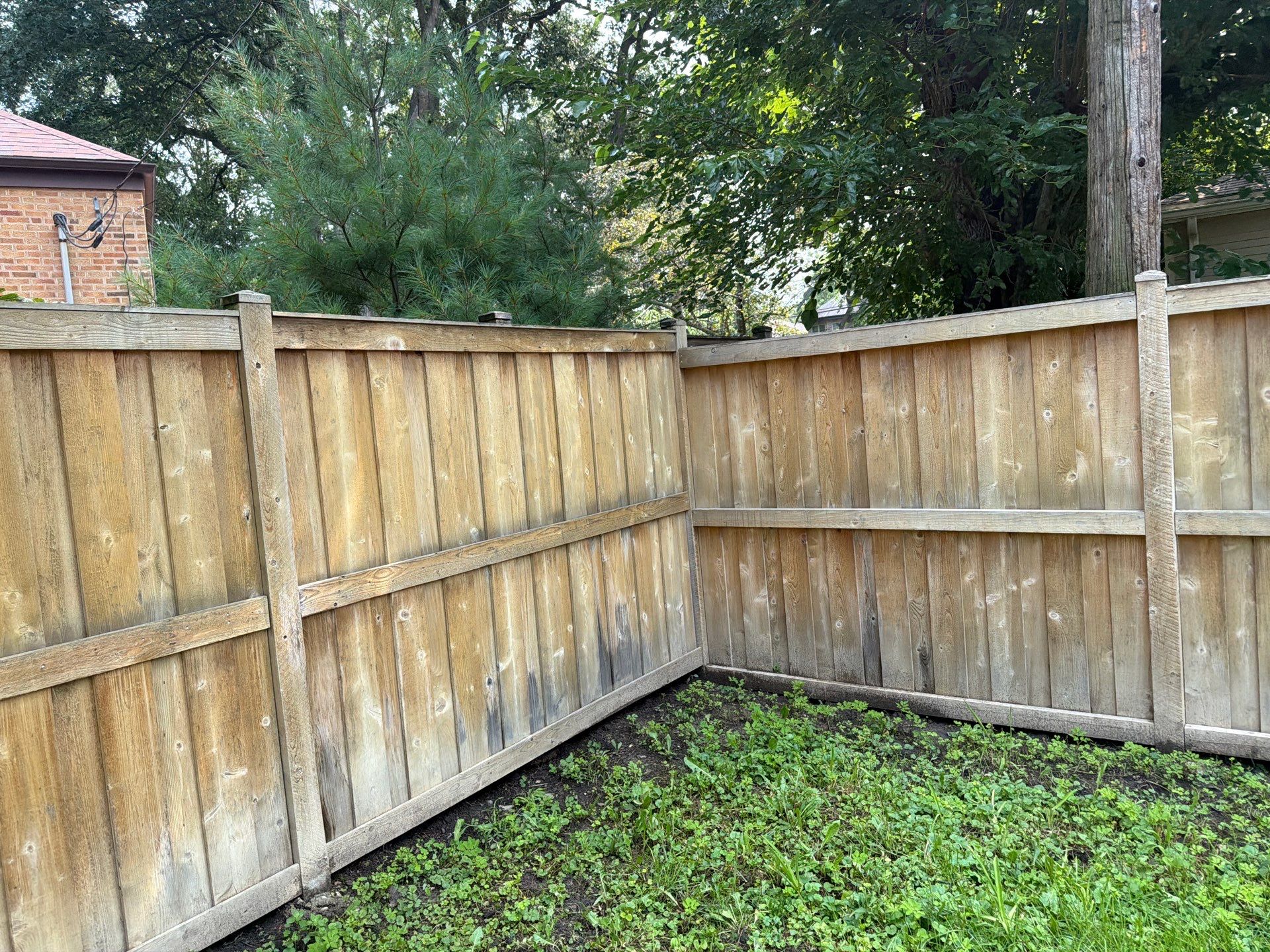 Wood fence cleaning and sealing by Northern Power Washing LLC.