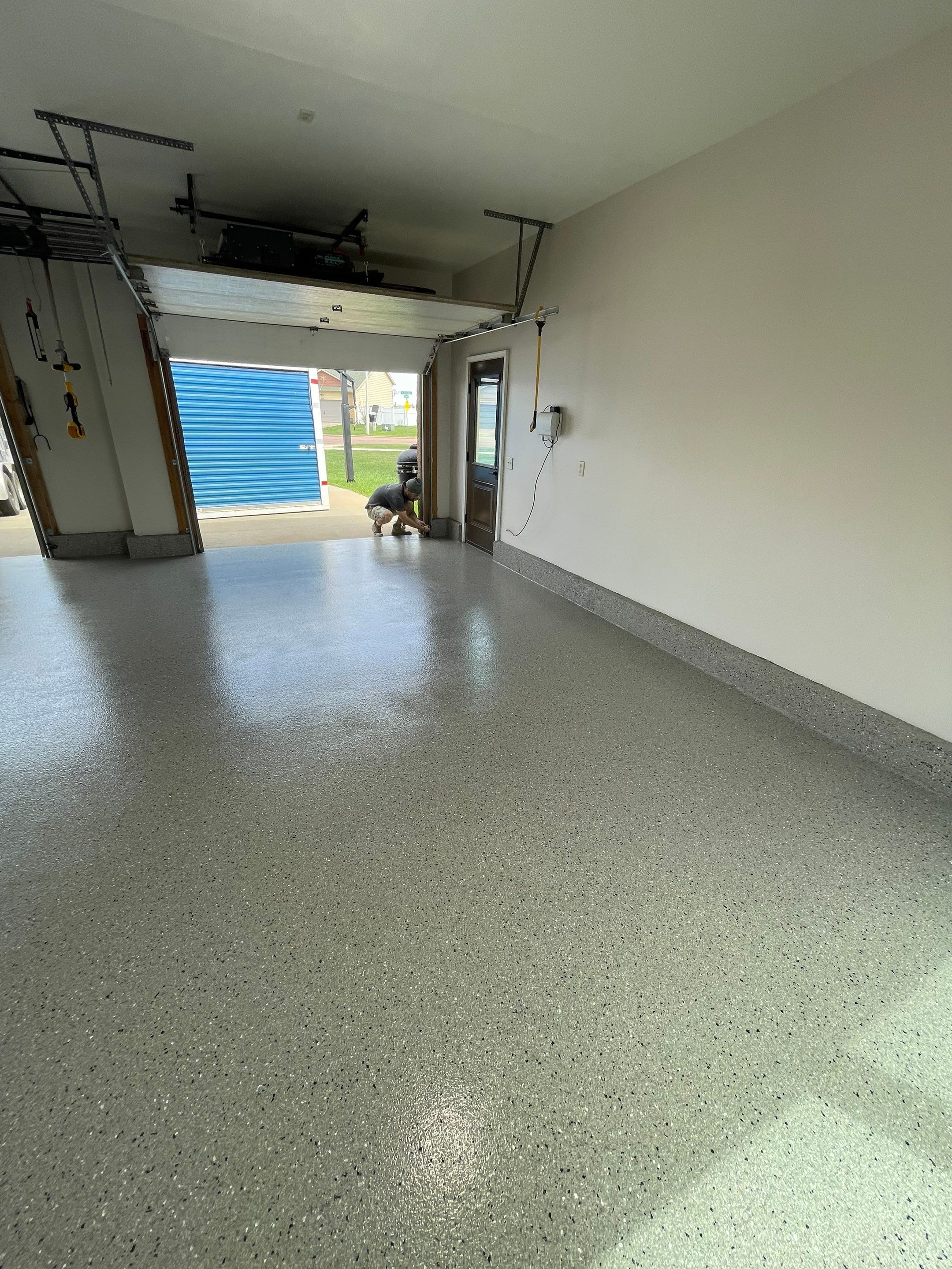 Residential Garage Floor Coating with Grey Speckled Epoxy Finish by Select Painting, Coatings & Garage Cabinets