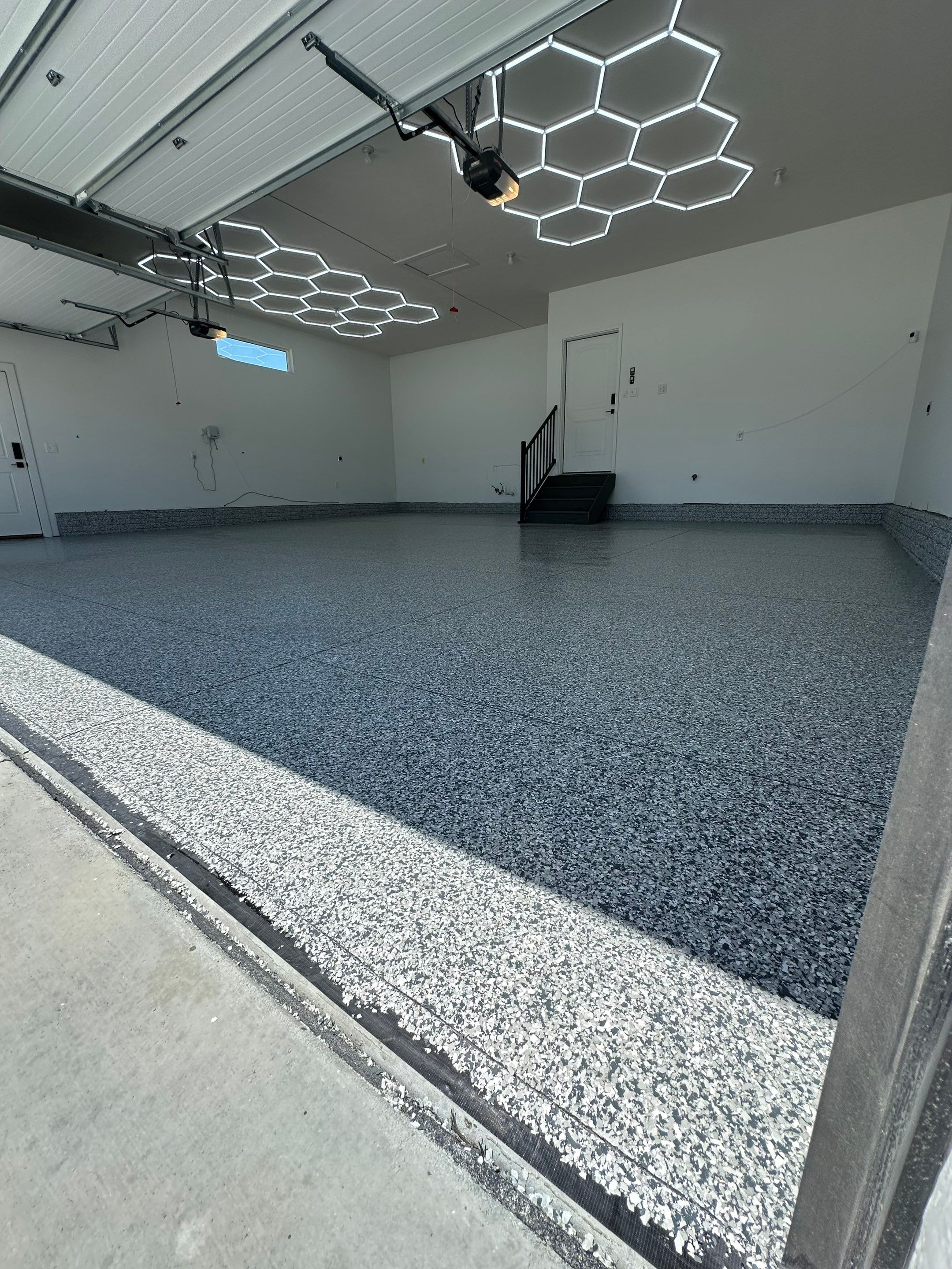 Three-Stall Garage Epoxy Floor Coating and LED Lighting in Lincoln by Goat Coatings