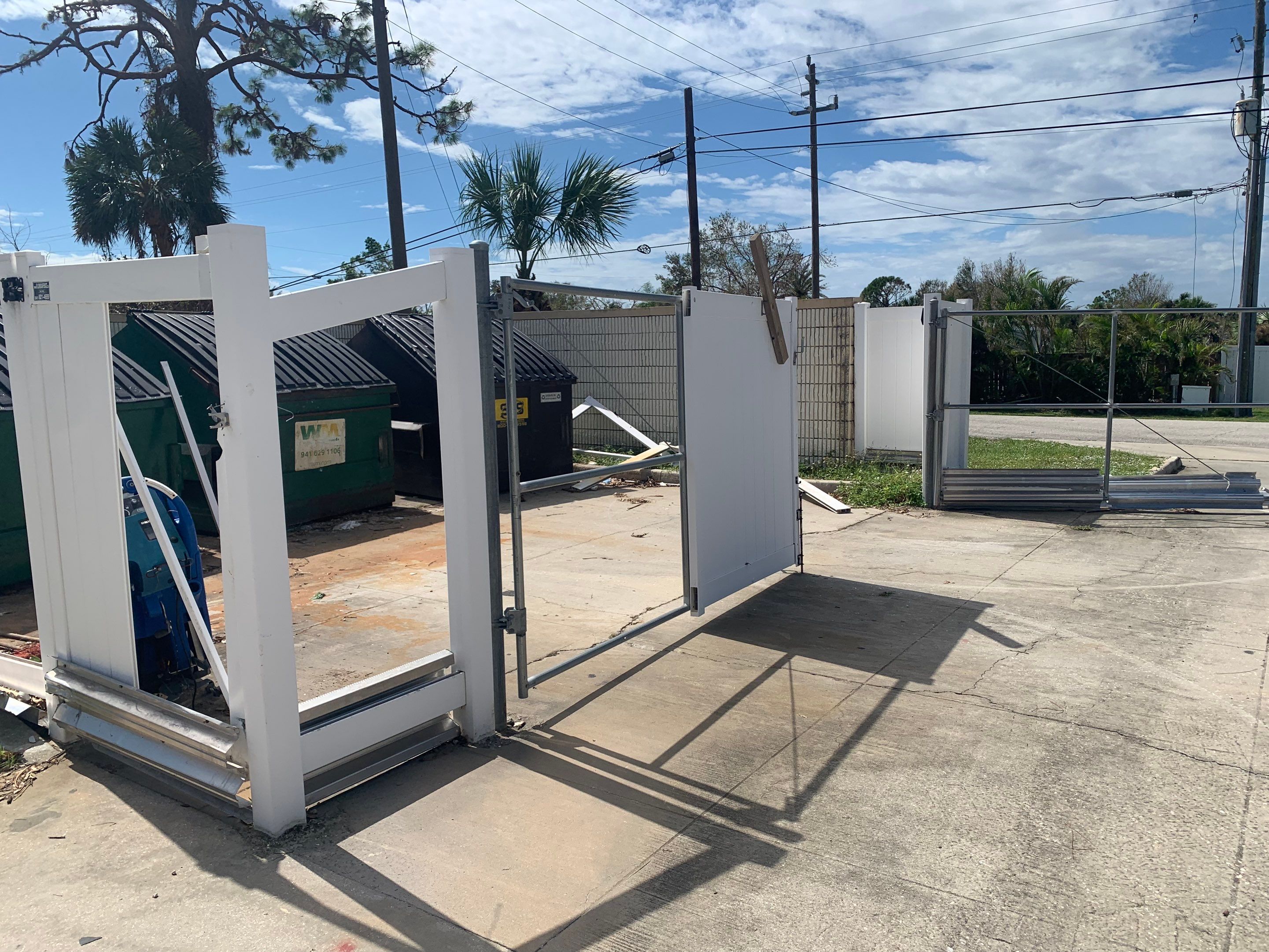 Commercial Chainlink and Vinyl Fence With Aluminum Framed Gates On Dumpster Enclosure by Asap fence and gates, LLC
