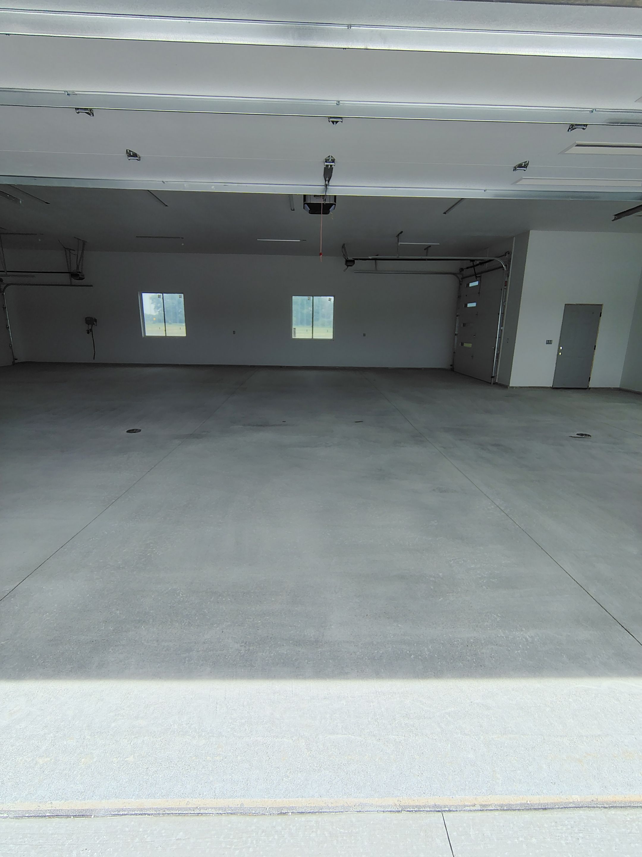 Multi-Bay Garage Concrete Coating and Floor Refinishing in South Dakota by Select Painting, Coatings & Garage Cabinets