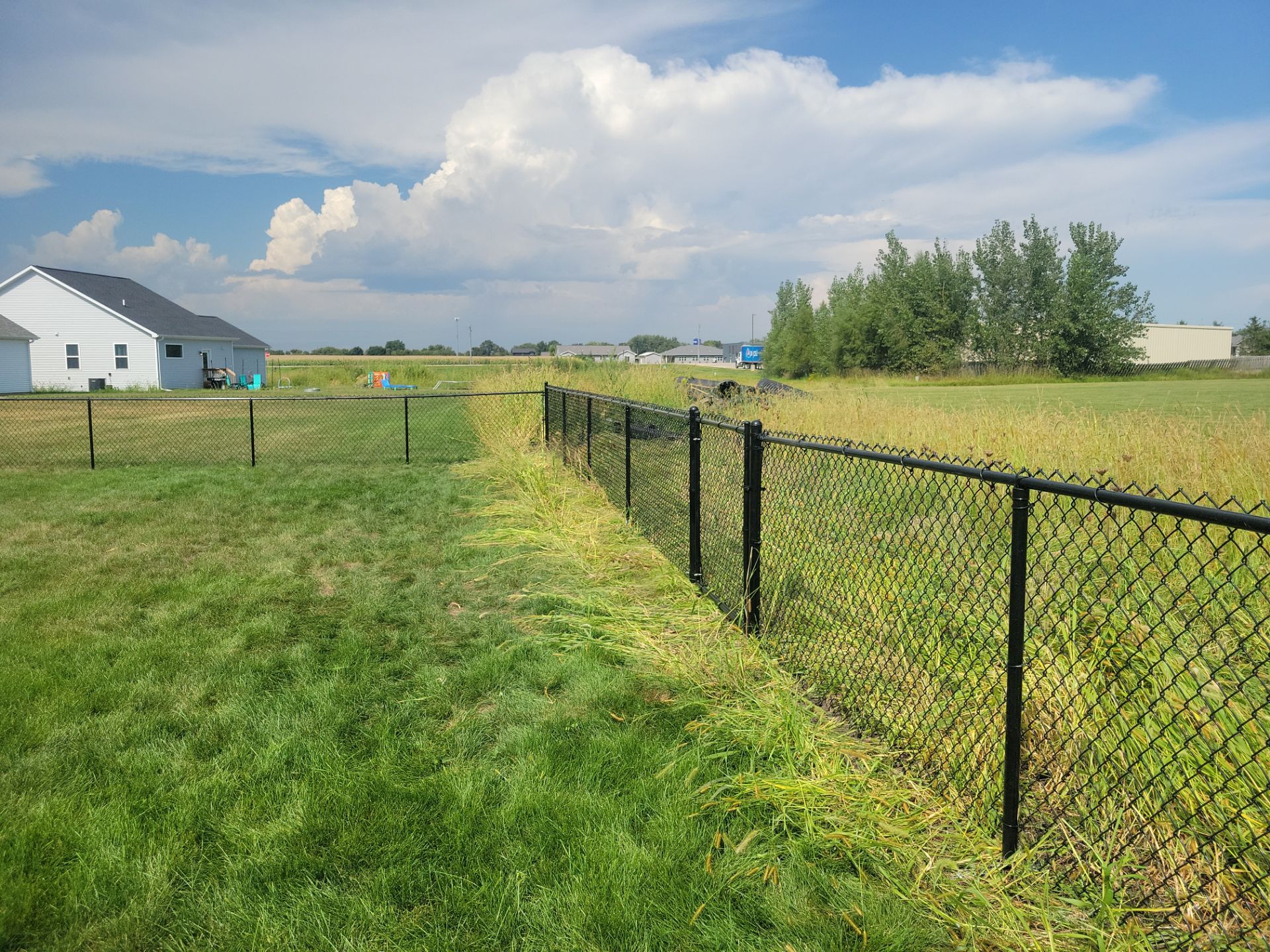 Residential Black Chain Link Fence Installation in Jesup by Perfect Picket Fence and Stain