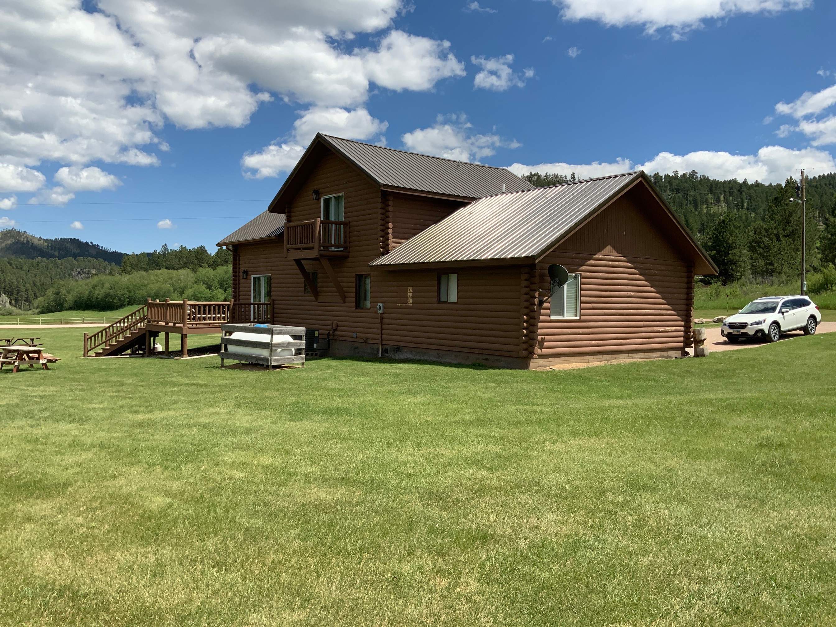 Hill Country Guest Ranch using Steel Roofing, Gutters, Log Cabin Staining by Lightning Exteriors