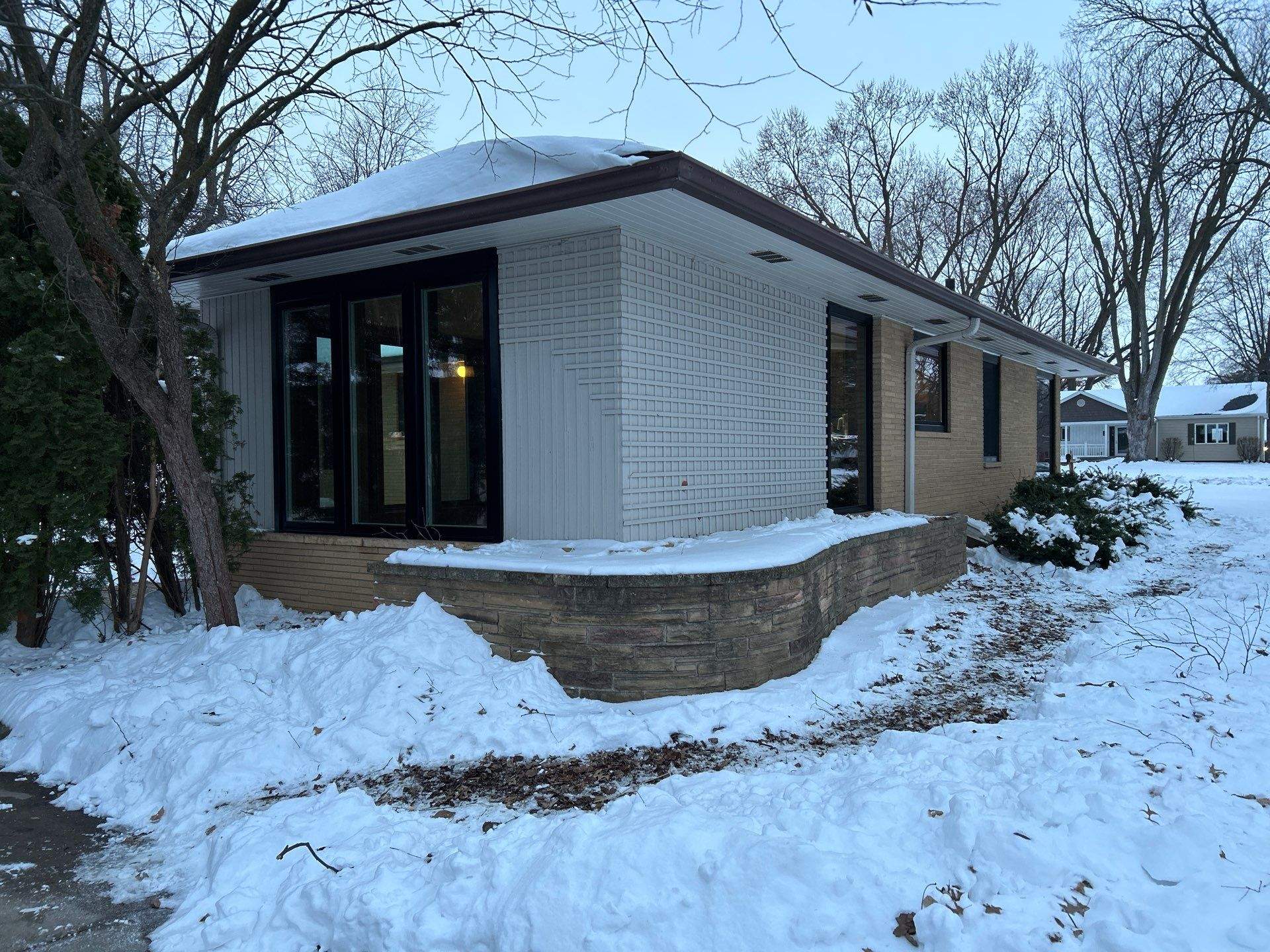 Black-Frame Pella Lifestyle Upgrade on a Partial Brick Home by United Windows and Siding LLC