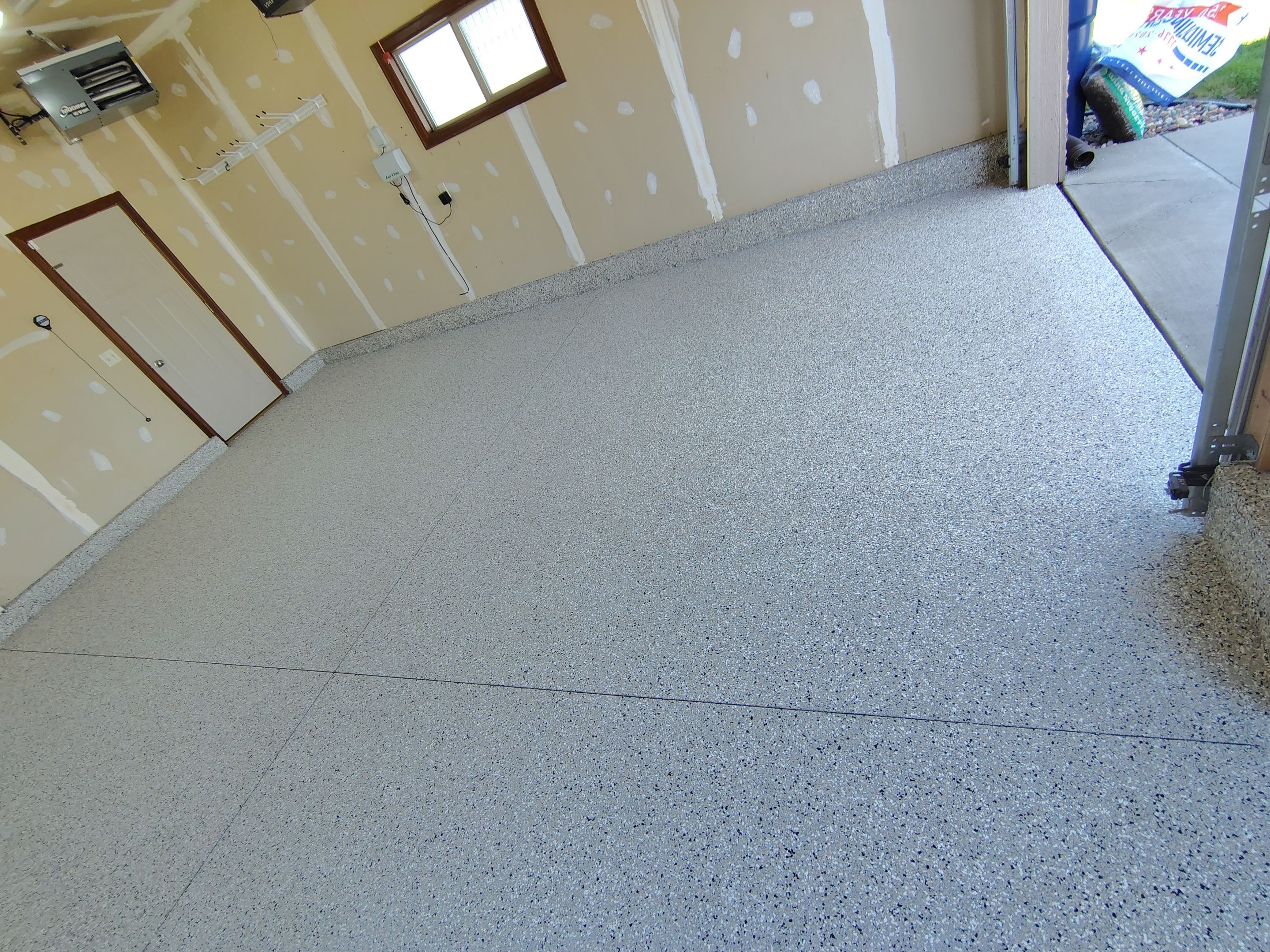 Multi-Car Garage Concrete Coating and Epoxy Finish in Sioux Falls by Select Painting, Coatings & Garage Cabinets