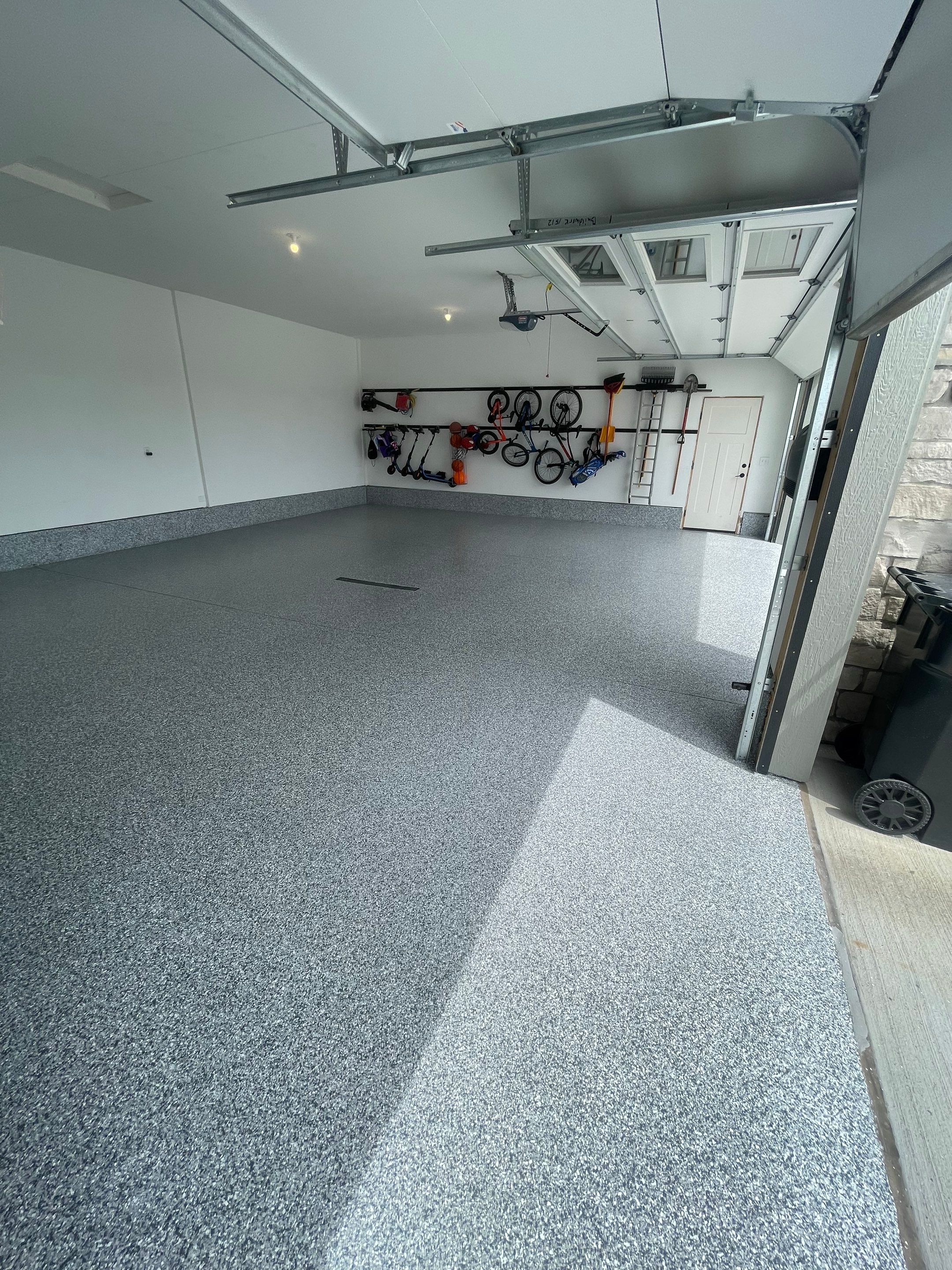 Full Garage Concrete Coating with Grey Speckled Epoxy in Brandon by Select Painting, Coatings & Garage Cabinets