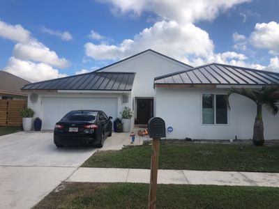 Residential Roofing Installation using 1" Nail strip metal roof
