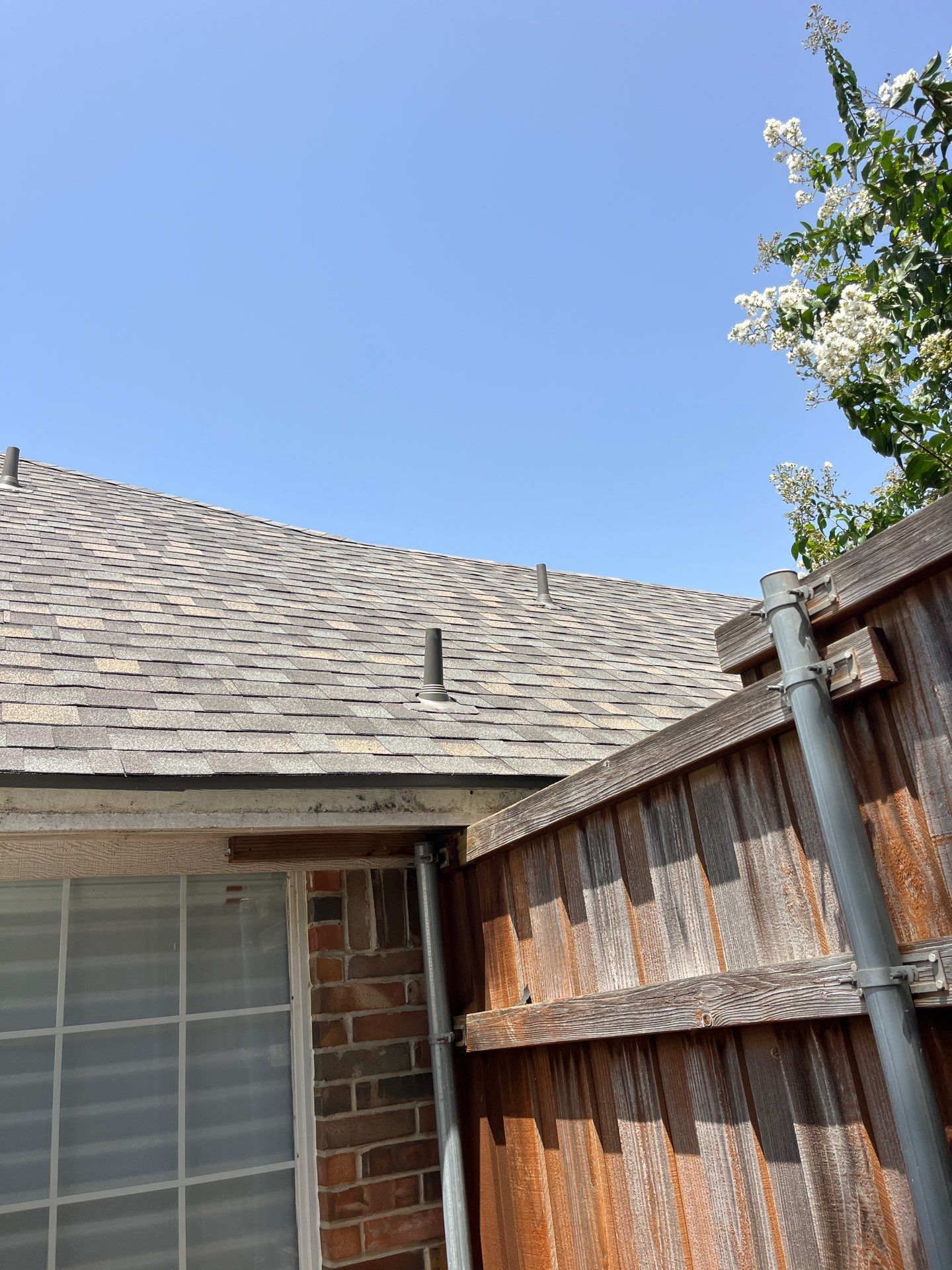 Red brick with IKO Cornerstone  by Tejas Roofworks + Restoration