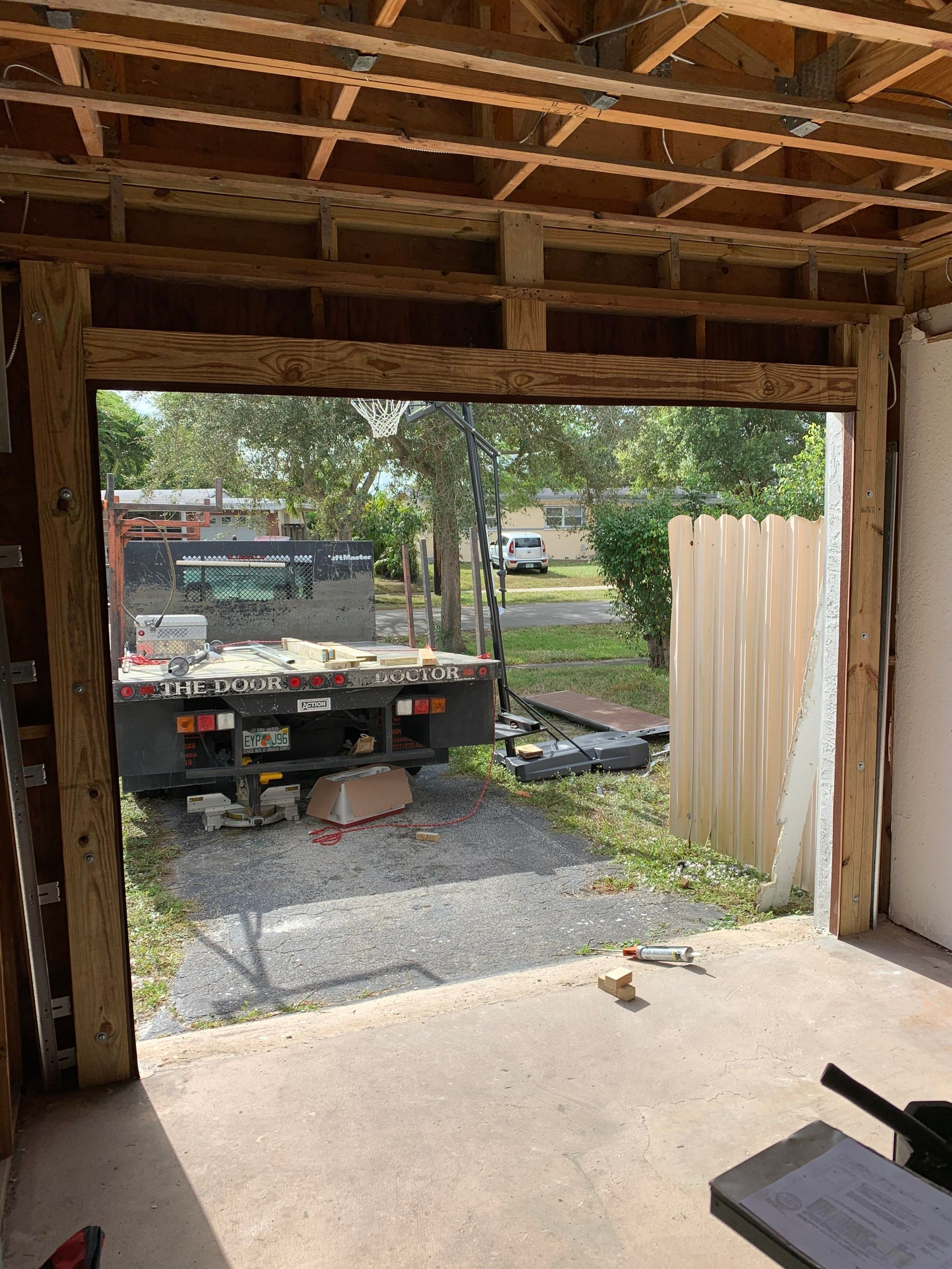 Sectional Garage Door Installation with Wood-Grain Finish in Sunrise - Clopay Modern Steel by The Door Doctor of South Florida, Inc.