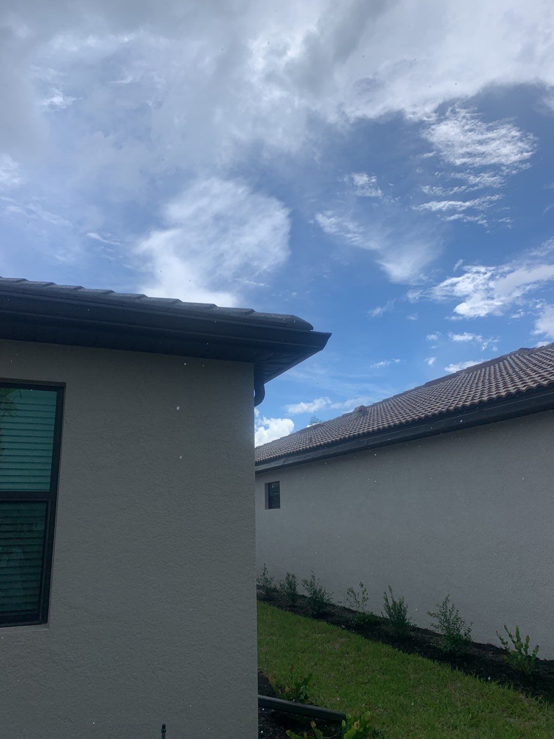 Seamless brown gutter and downspouts installation in Estero, FL  by Gutter Professors