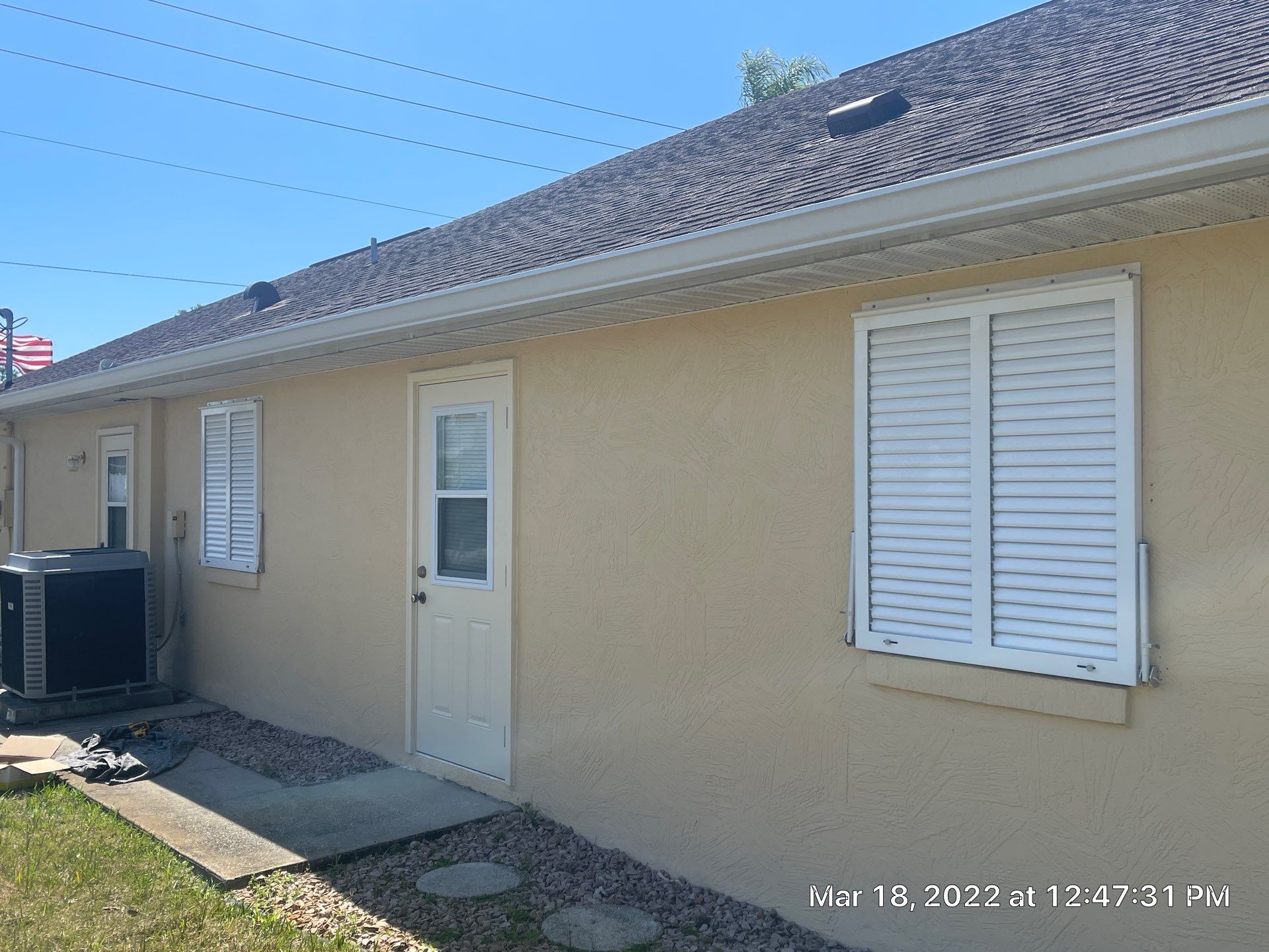 Bahama Shutters with front slide locking pin by Smart Guard Shutters