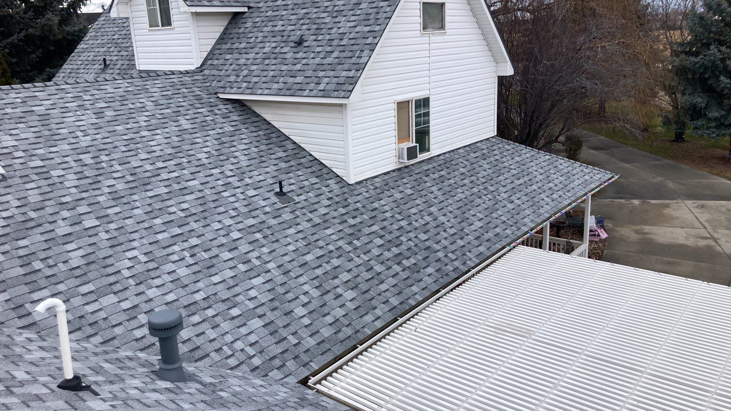 Two story farmhouse style roofing installation using Owens Corning Duration in the color Teak by ID Roofing LLC