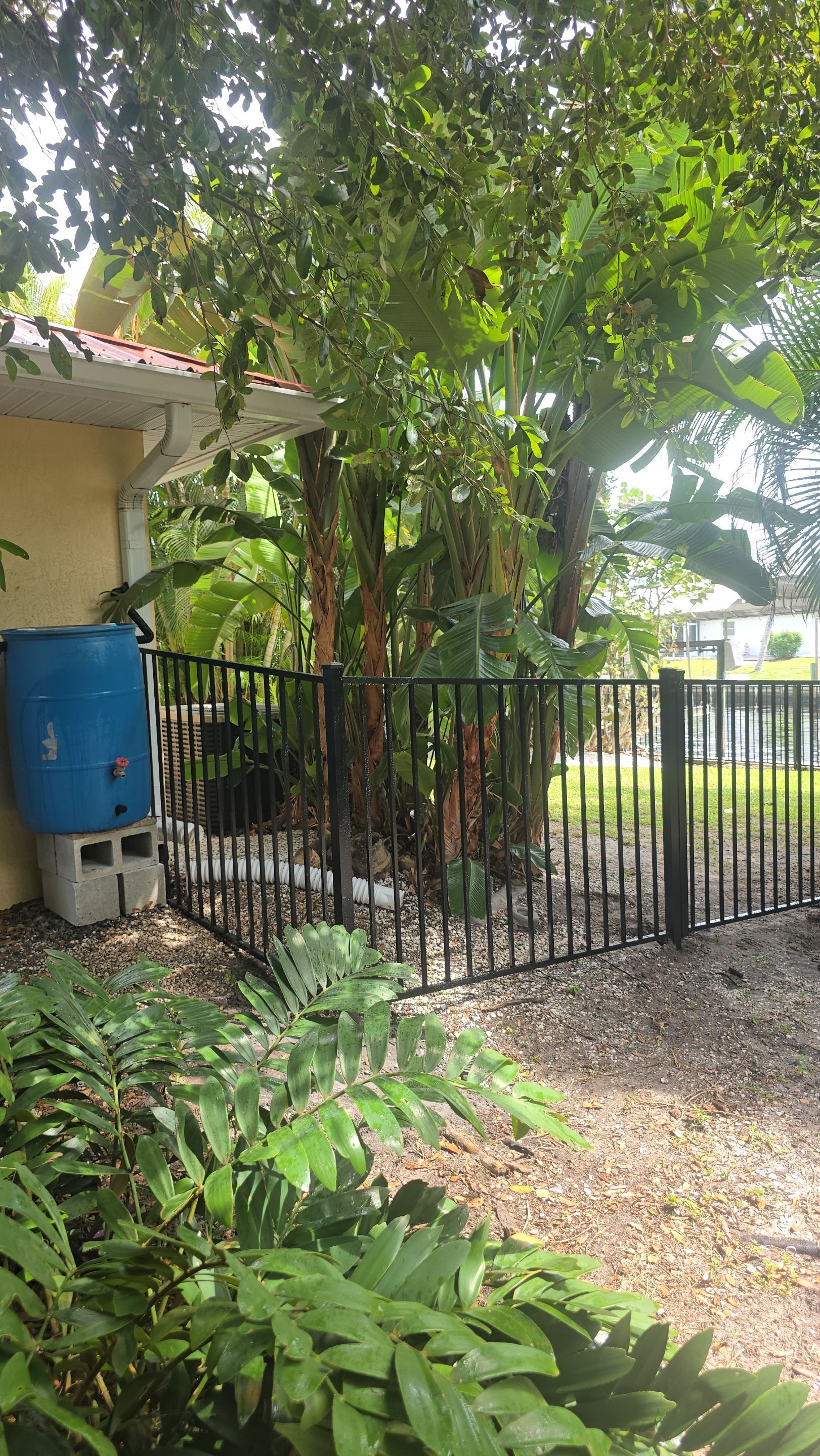 Black Aluminum Picket Fence Installation for Port Charlotte Canal Home by True Fence LLC