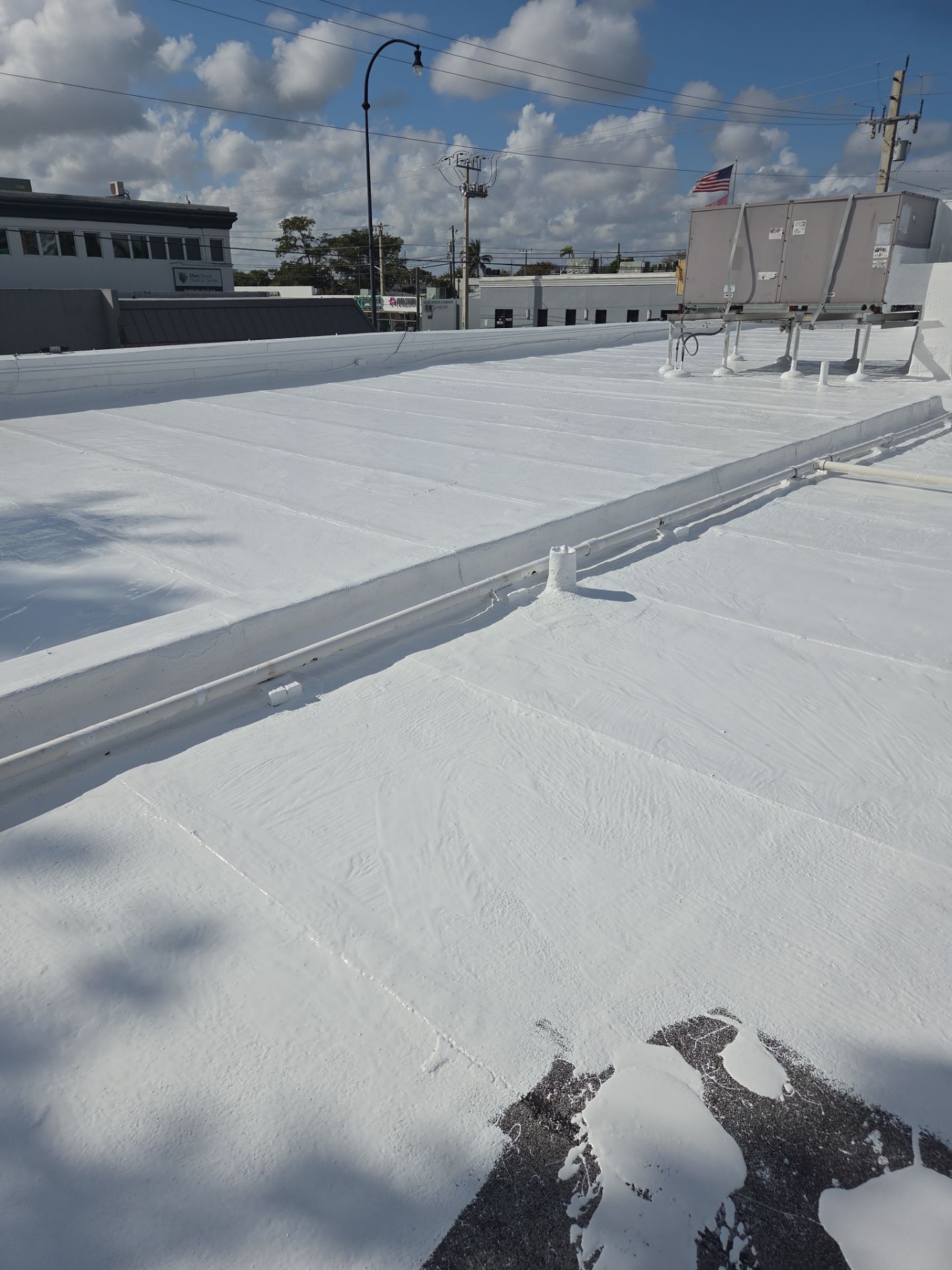 Commercial Flat Roof Restoration Using Silicone Coating in Hallandale Beach by Aastro Roofing