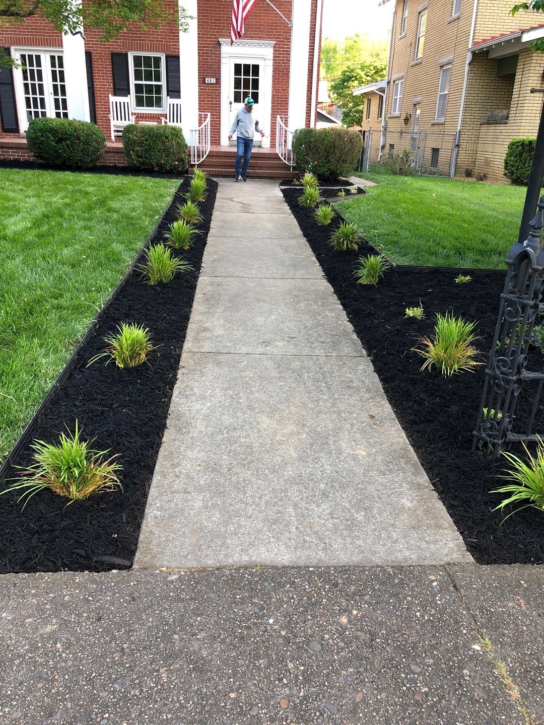 Liriope grasses, mulch and stone pavers by GrassBusters, Inc.