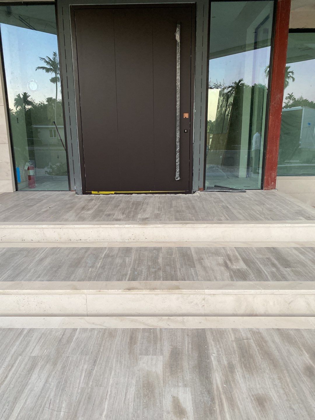 Custom Material Pivot Door installation by Impact Precious Wood Inc.