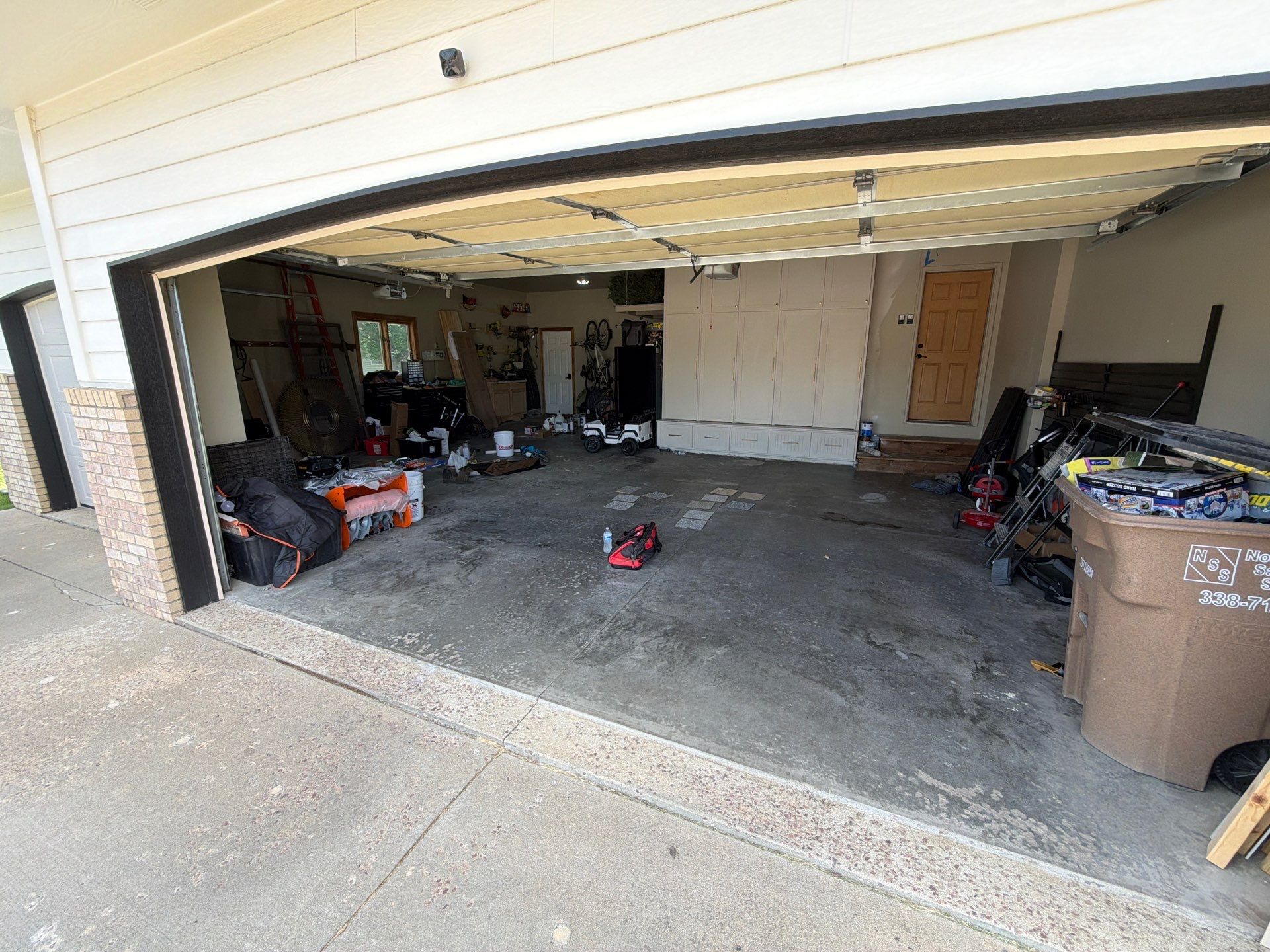 Cabin FEver Flake Garage Floor Coating Installation in Sioux Falls by Select Painting, Coatings & Garage Cabinets