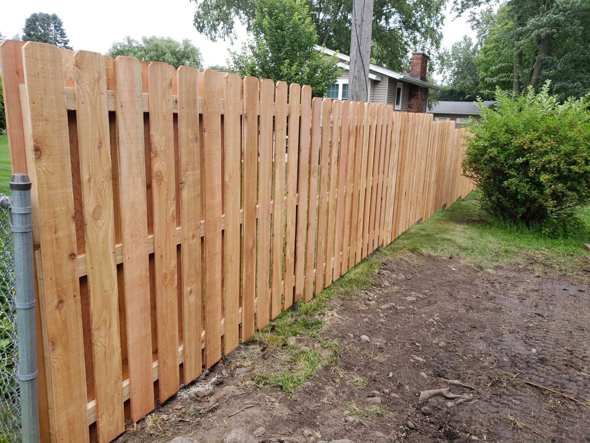 Unstained Cedar Wood Privacy Fence Installation in Cedar Falls by Perfect Picket Fence and Stain