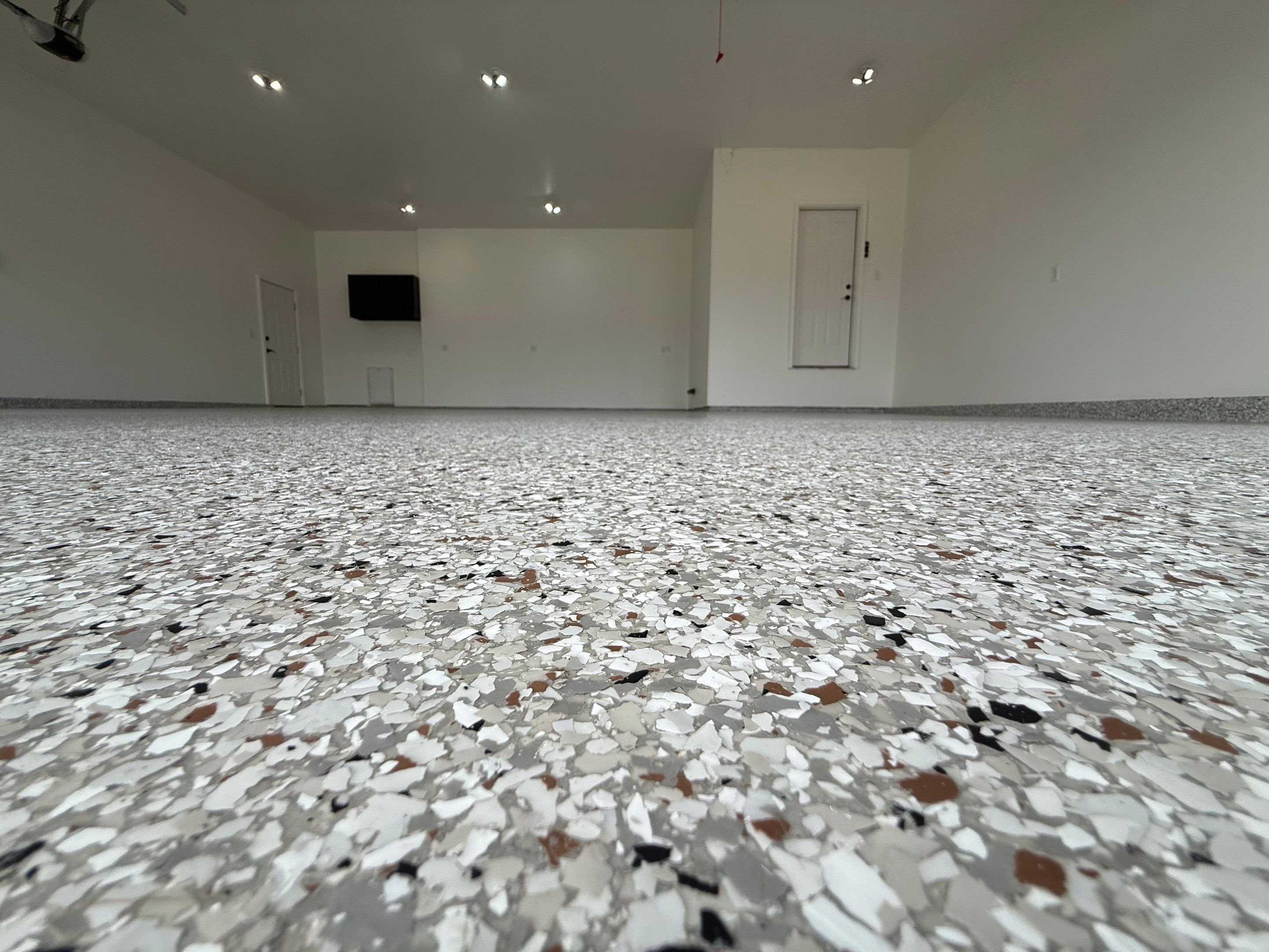 Full Garage Floor Resurfacing and Decorative Epoxy Flake Finish by Select Painting, Coatings & Garage Cabinets