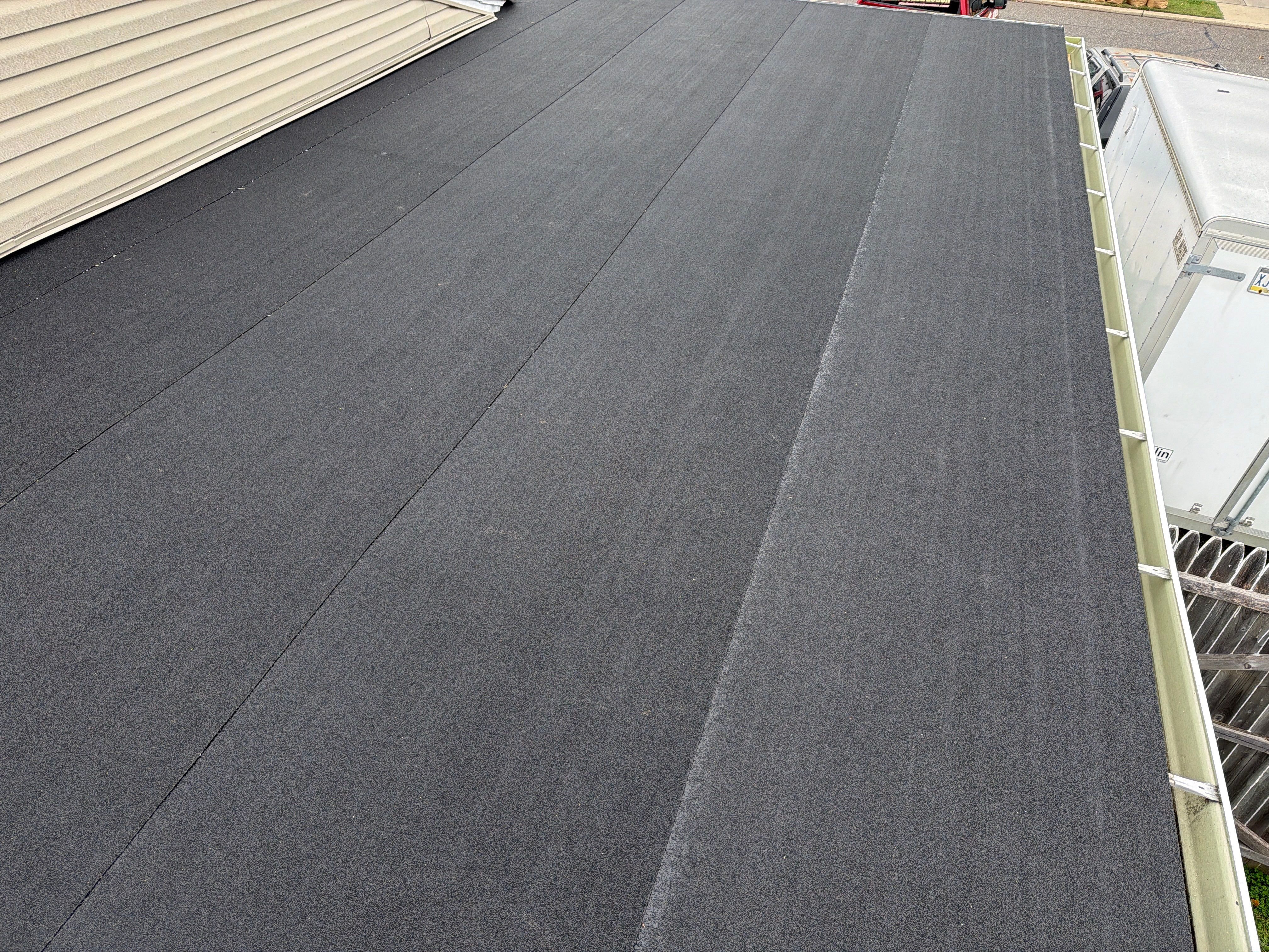 Flat Roof Replacement and Shingle Integration in Levittown by Stofan Construction LLC