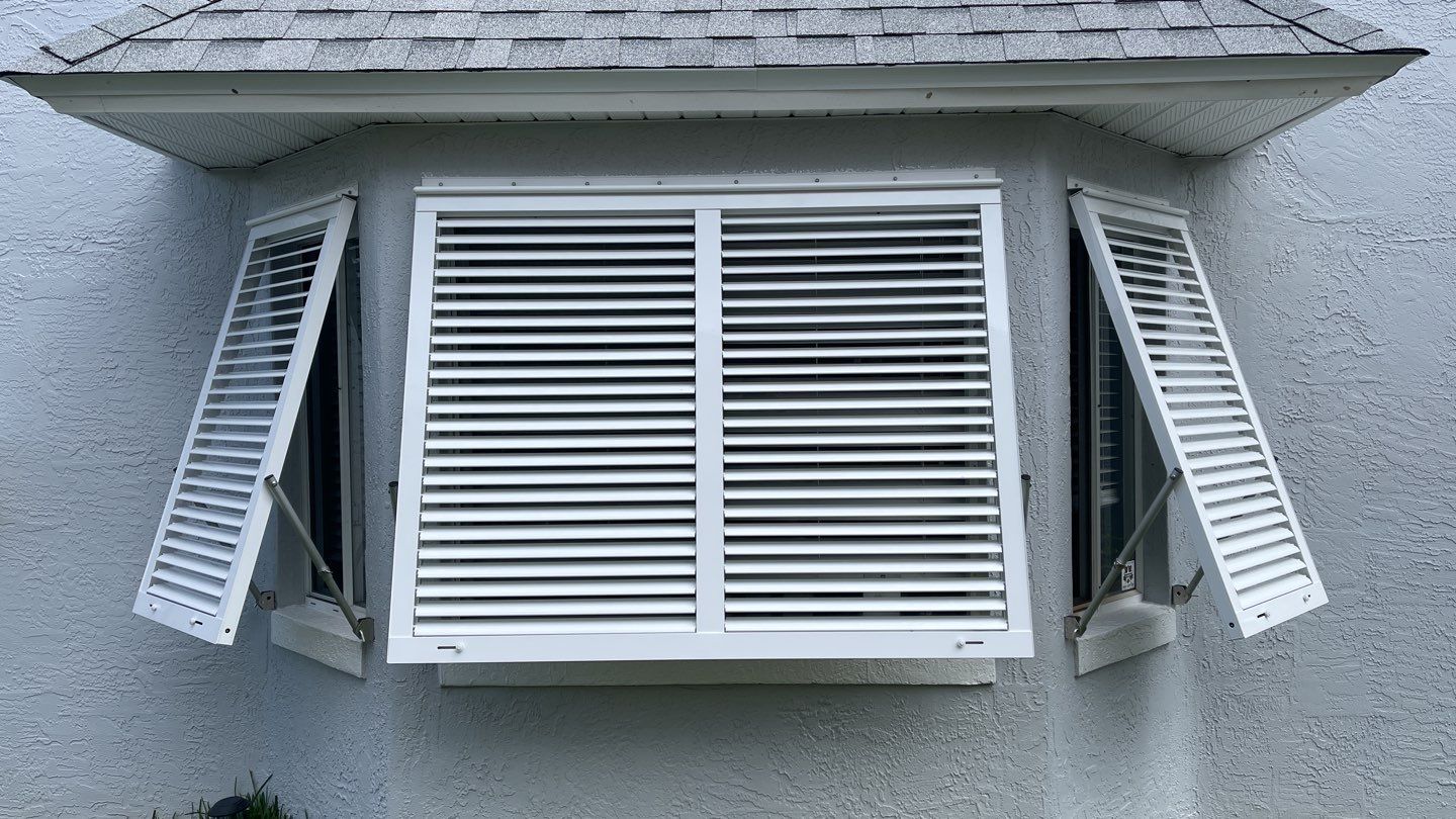 Accordion shutter and Bahama with front slide rod by Smart Guard Shutters