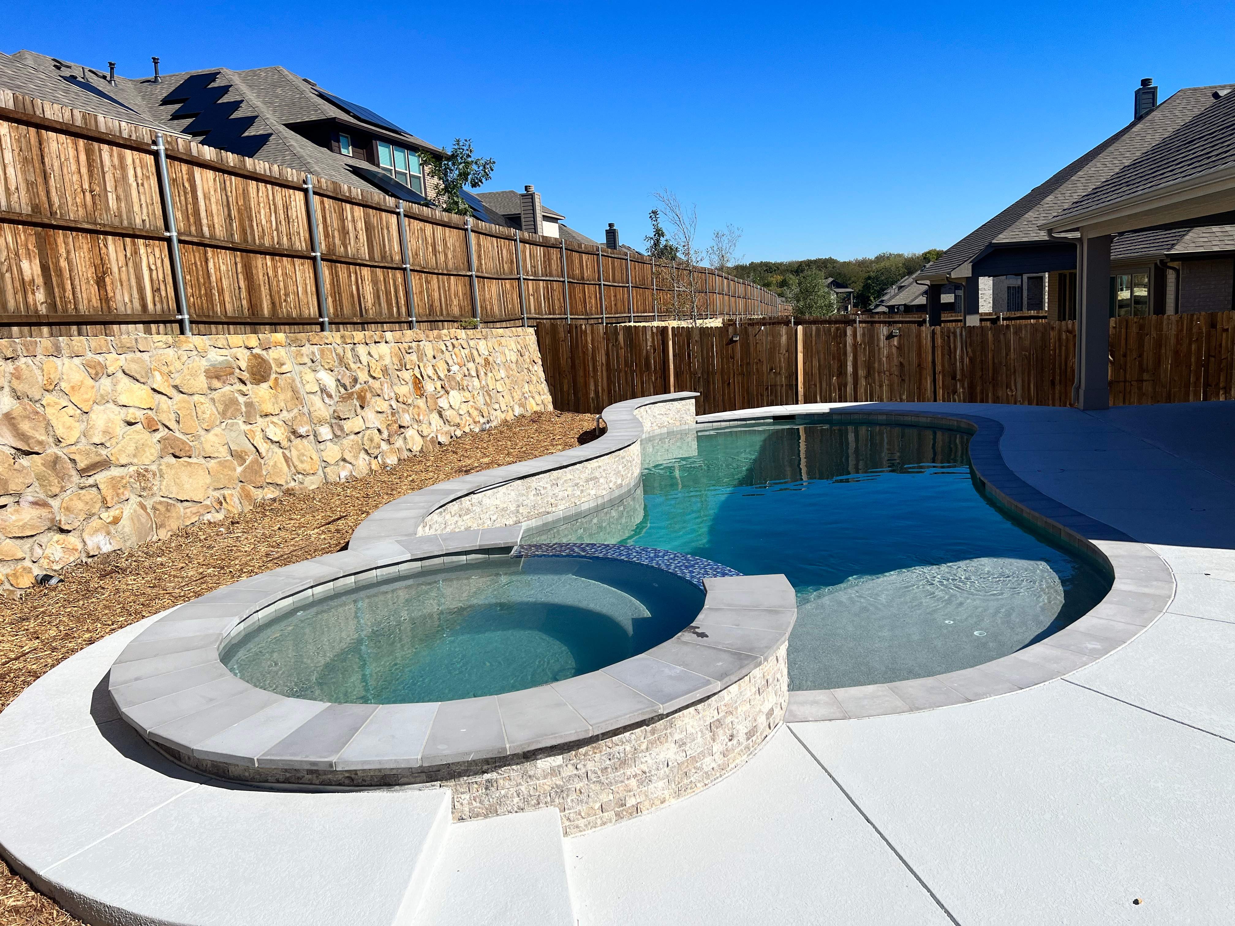 Freeform Pool with Raised Spa and Stone Coping by Pinnacle Pools and Spas - DFW