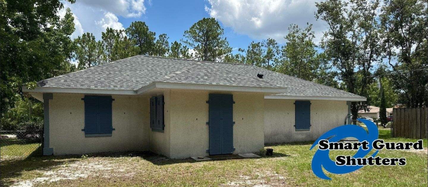 Impact Rated Colonial Shutters in Pigeon Blue by Smart Guard Shutters