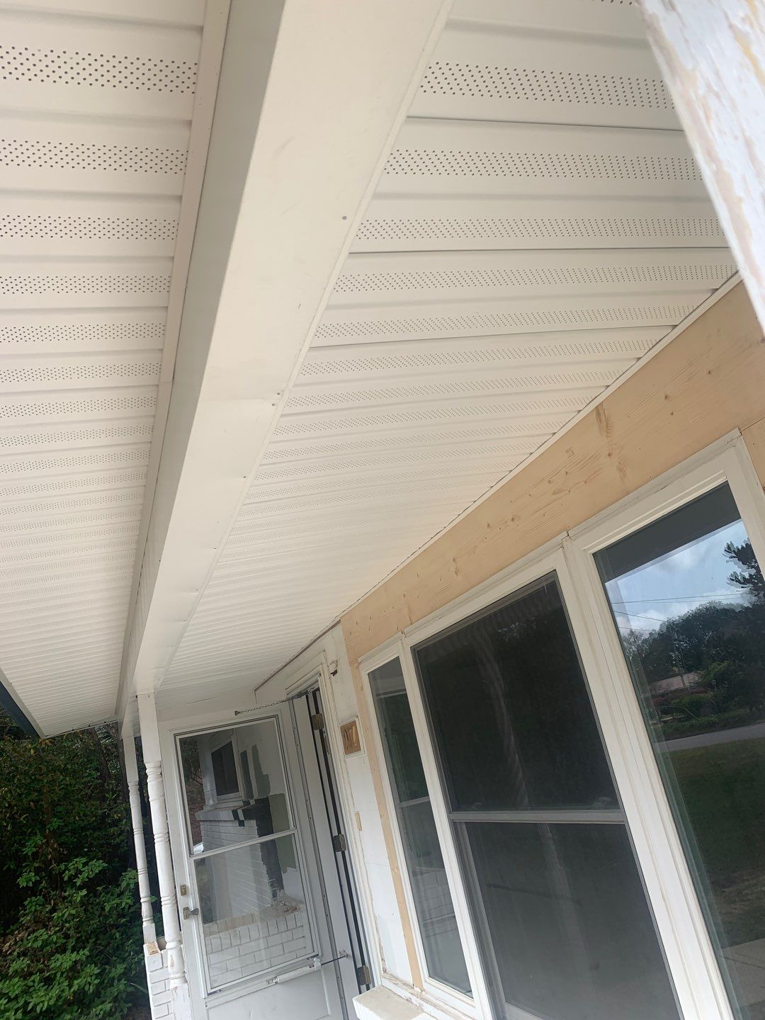 White Seamless Gutters and Black Downspouts by Gutter Professors