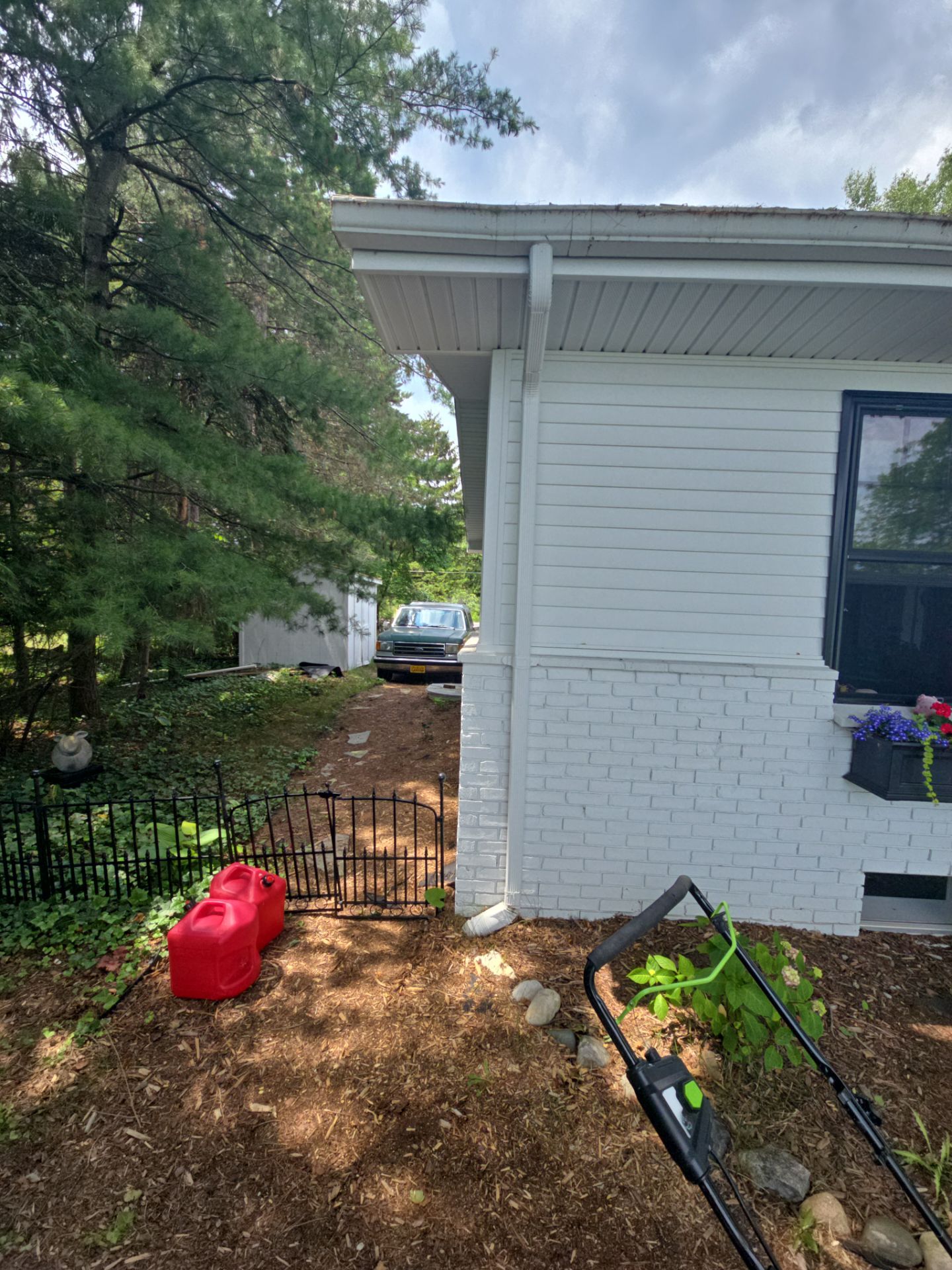 Black Gutter and Gutter Helmet Installation for Suttons Bay Home by Rainbow Seamless Systems