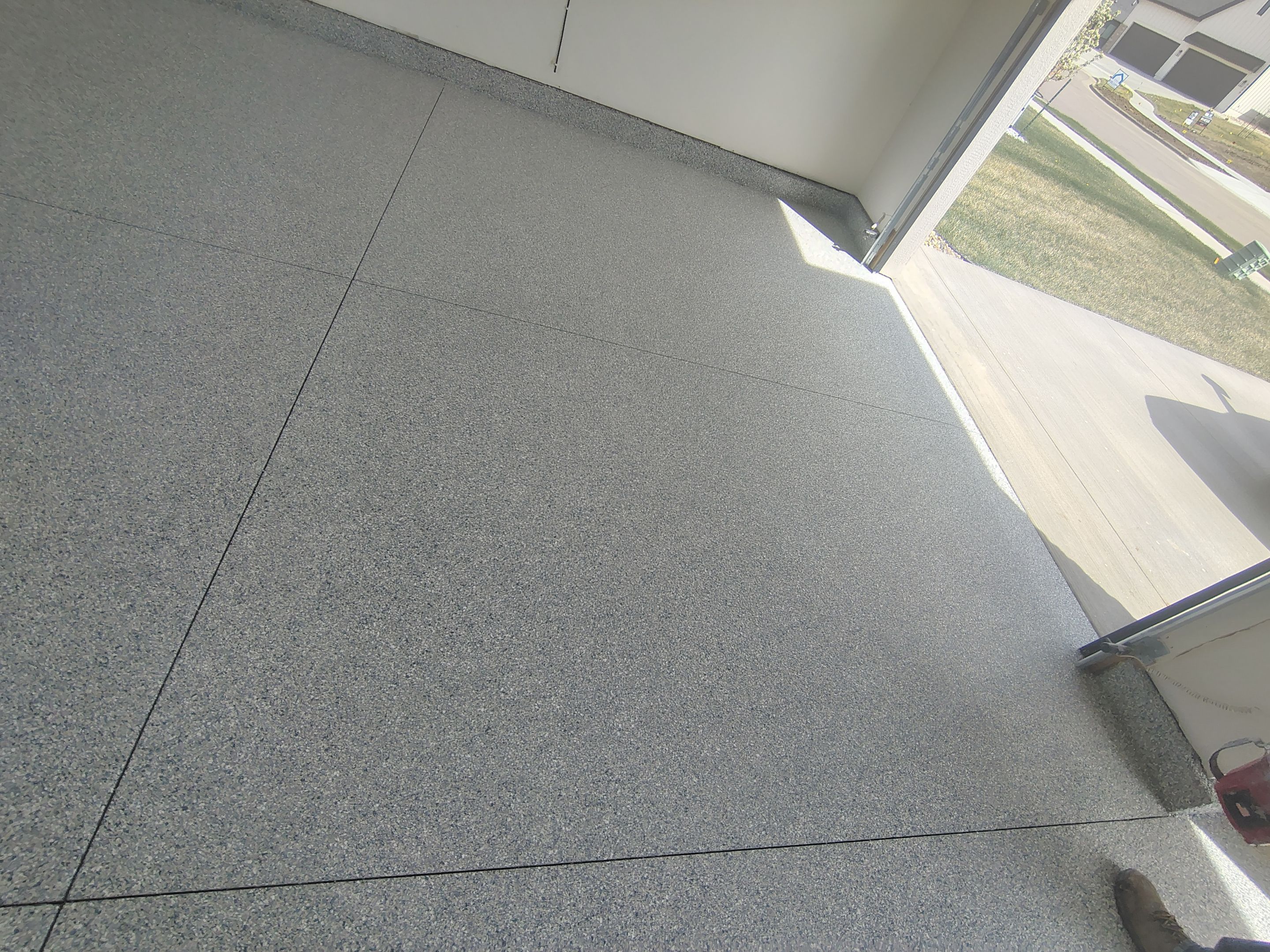 Sioux Falls Garage Floor Transformation with Gray Decorative Flake Coating by Select Painting, Coatings & Garage Cabinets