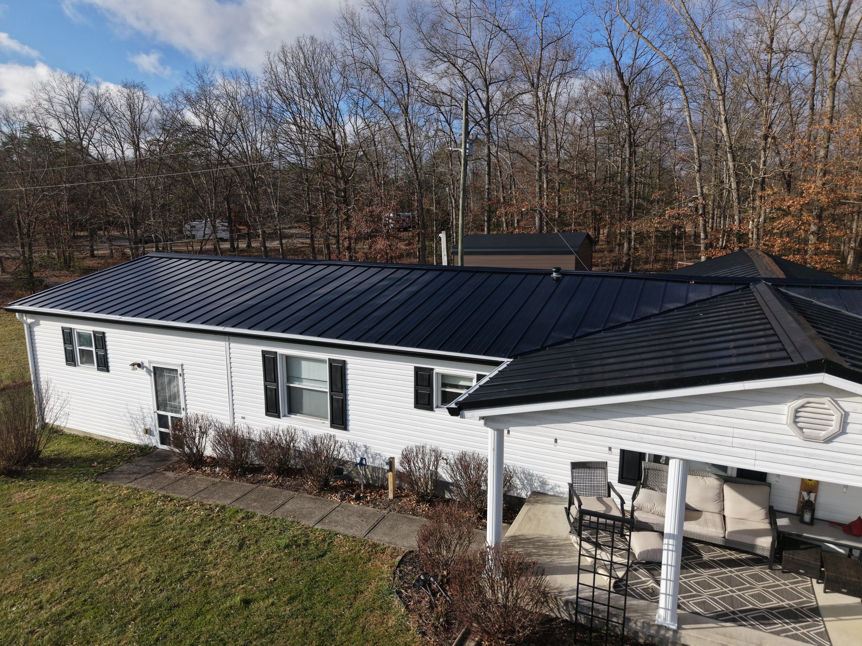 Standing Seam Roof & Black Gutters by Stout Exteriors