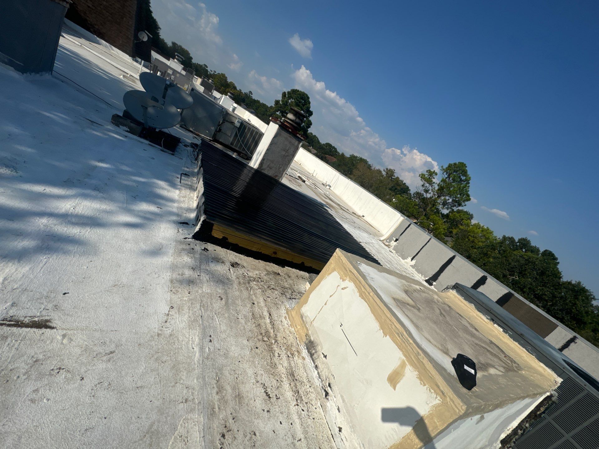 Waterproofing AC Curb covered courtyard on a flat Roof by Associates Roofing Unlimited
