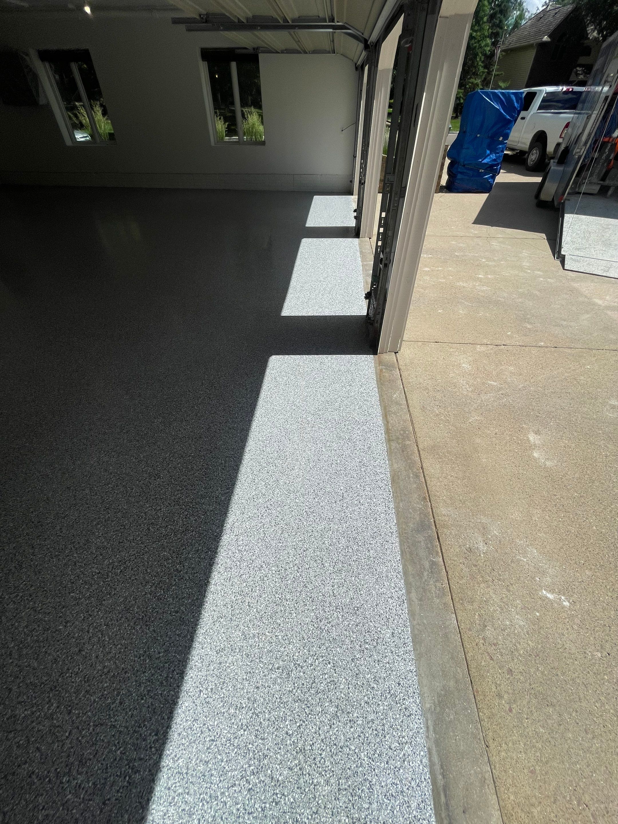 Gray Speckled Epoxy Garage Floor Coating in Sioux Falls by Select Painting, Coatings & Garage Cabinets