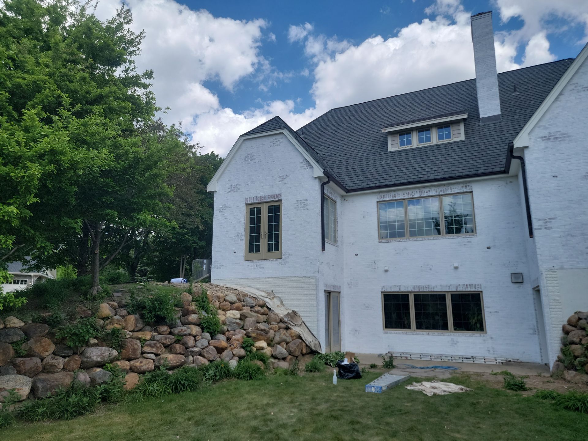 Residential Exterior Brick Painting and Limewash Refresh in Sioux Falls by Select Painting, Coatings & Garage Cabinets