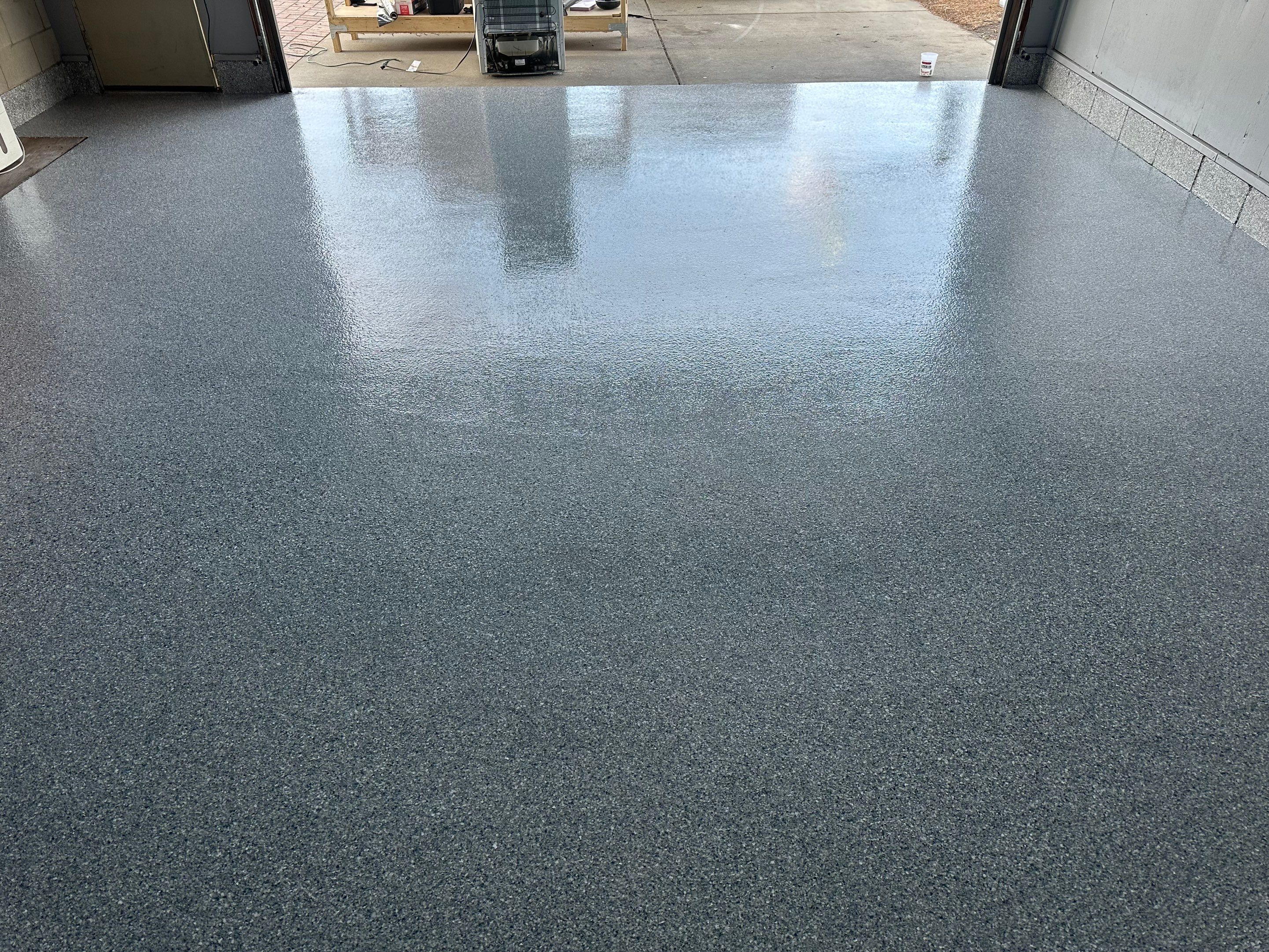 Multi-Colored Speckled Concrete Floor Coating Installation in Sioux Falls by Select Painting, Coatings & Garage Cabinets