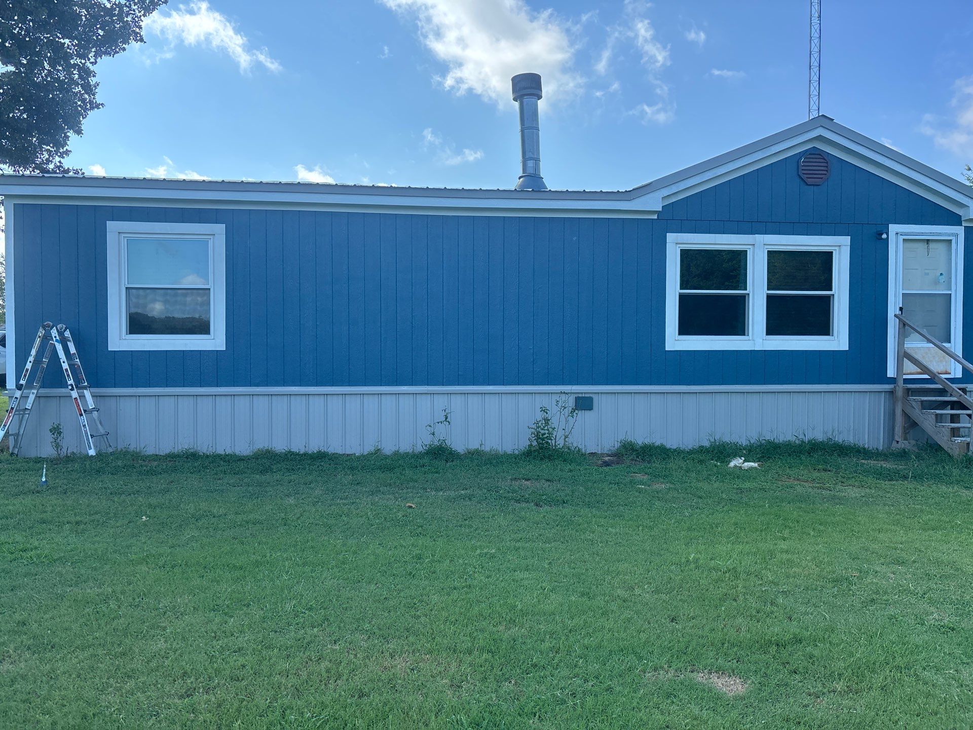 Exterior Painting in Fruitvale, TX | Wood Porch & Home in Deep Navy Blue by Quality Coats Painting