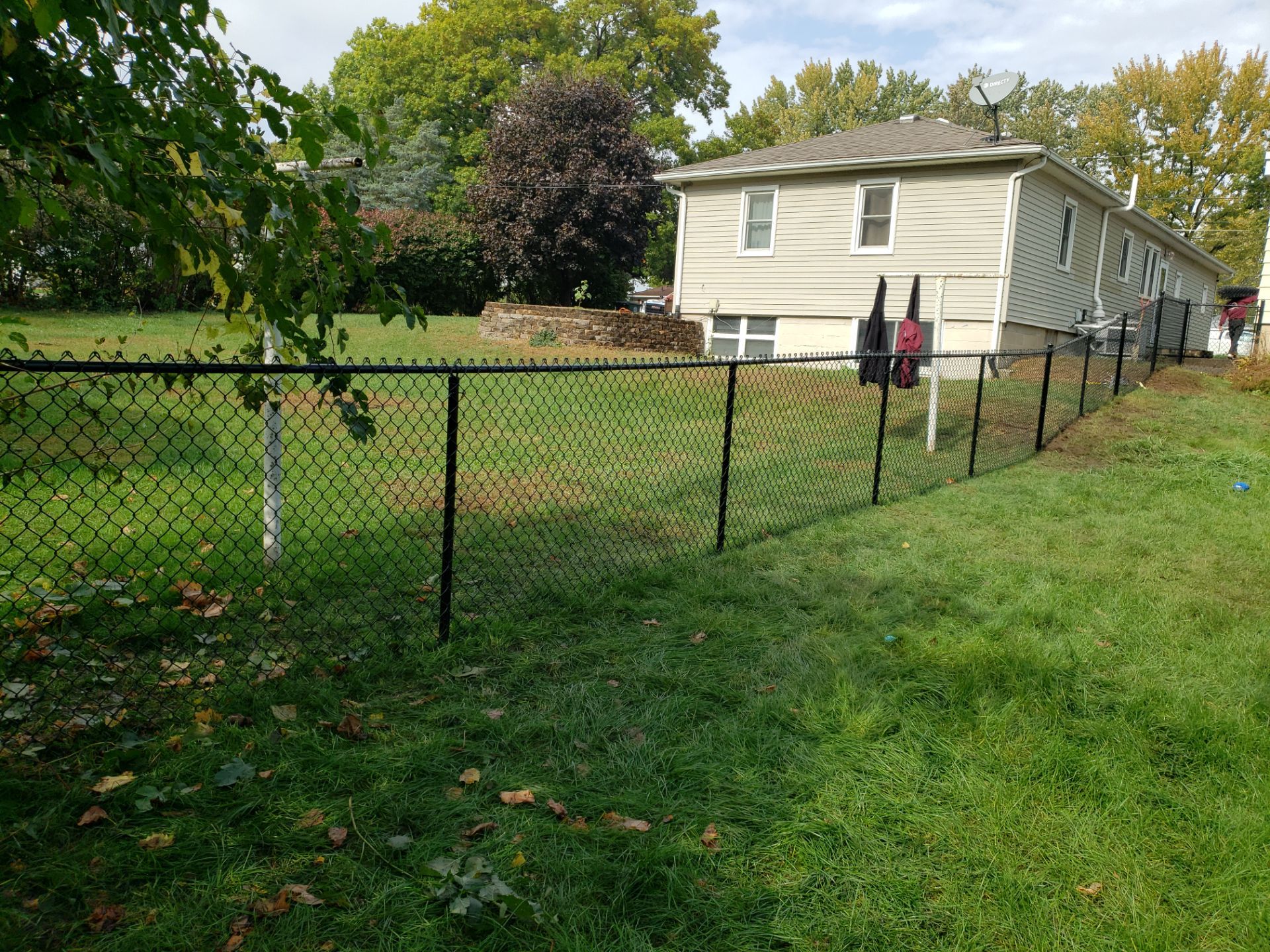 Residential Black Vinyl-Coated Chain Link Fence in Waterloo by Perfect Picket Fence and Stain