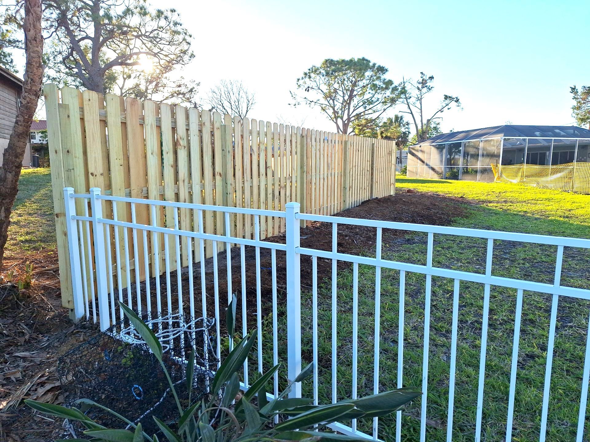 Wood Fence Installation using 6ft Pressure-Treated Wood Board-On-Board Privacy Fence with a 4Ft 3 Rail White Aluminum Fence by Asap fence and gates, LLC