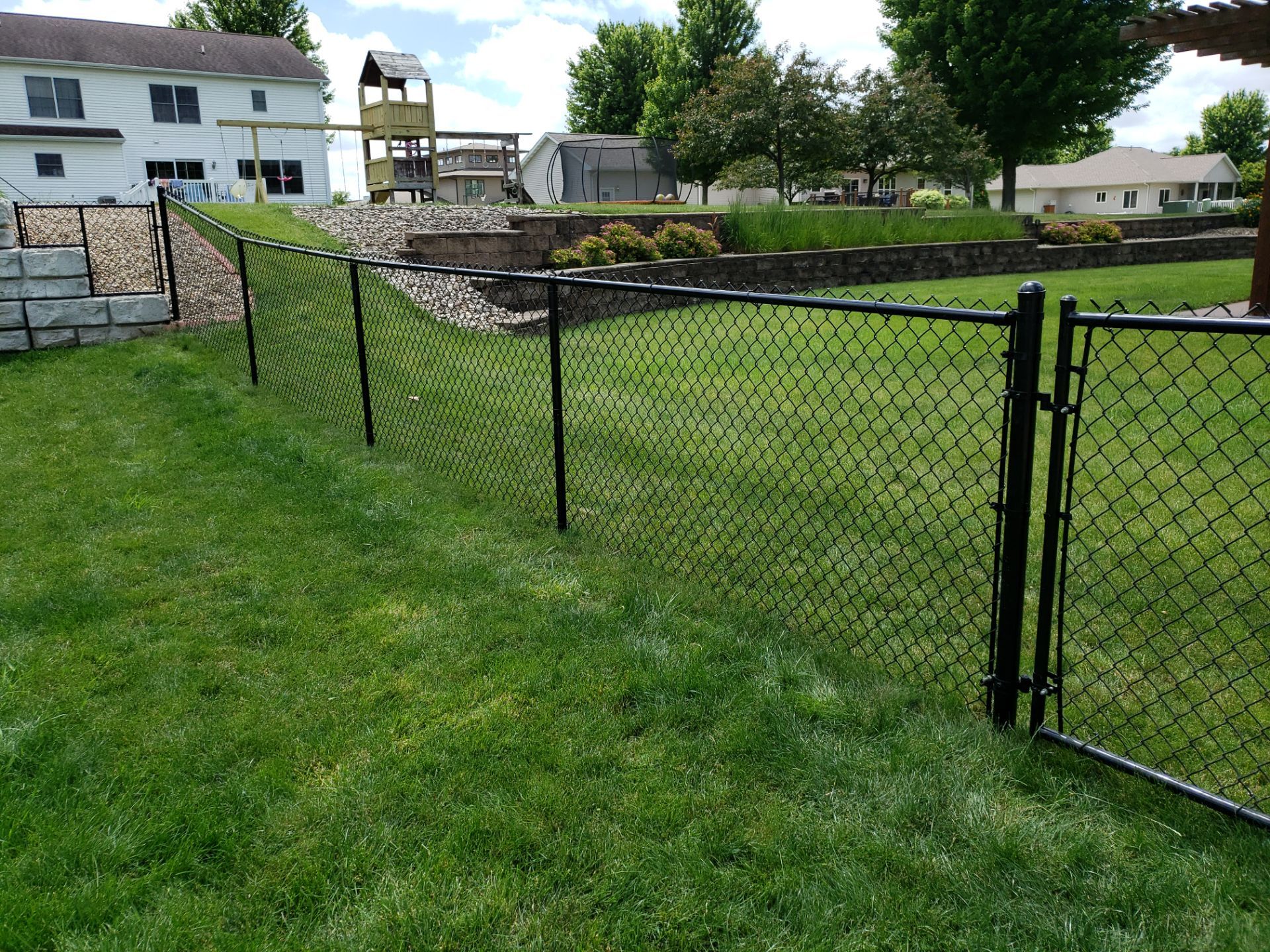 Black Vinyl-Coated Chain Link Fence Installation in Denver by Perfect Picket Fence and Stain