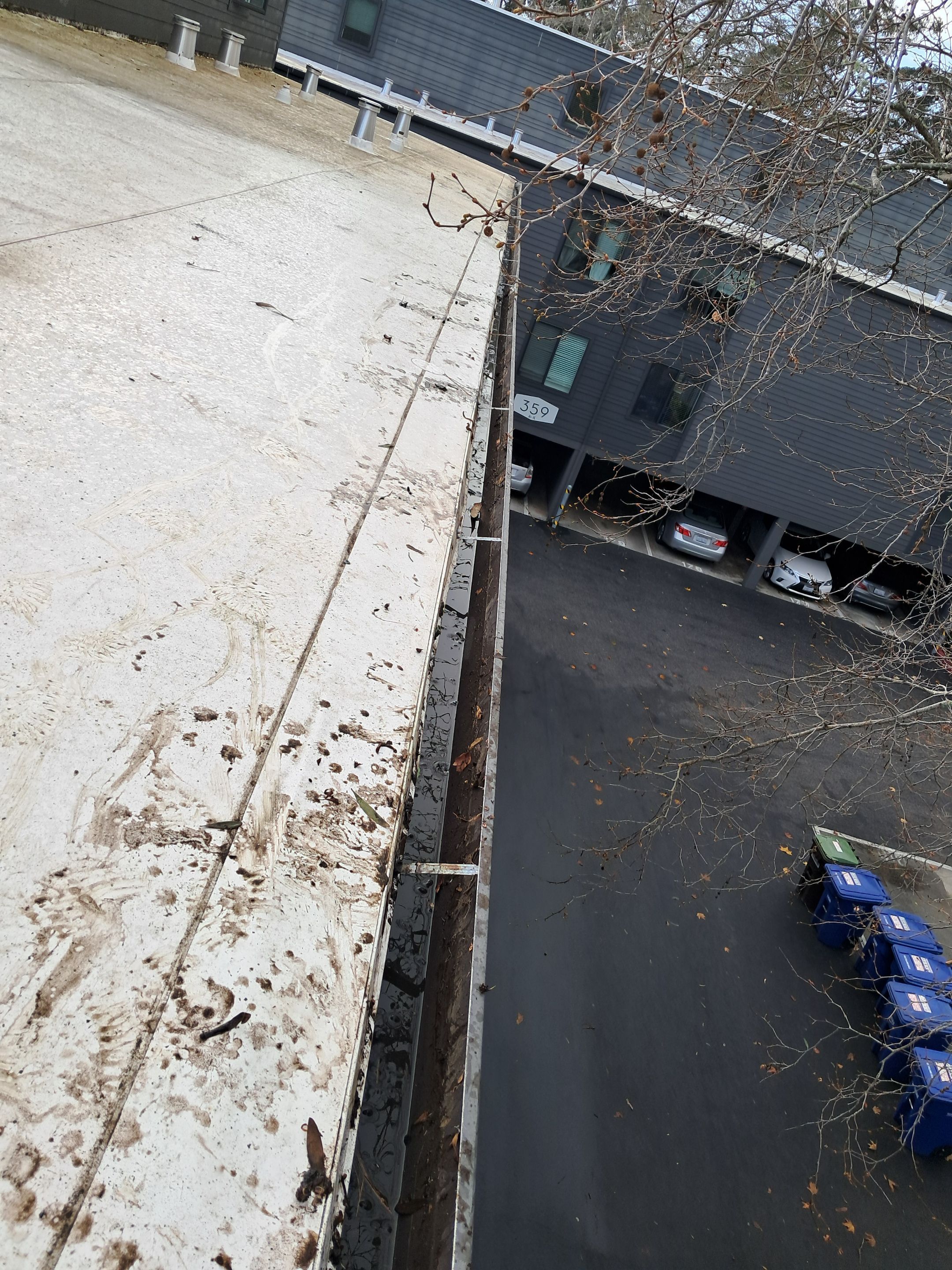 HOA gutter cleaning in Santa Cruz,  after  photo showing full gutters.