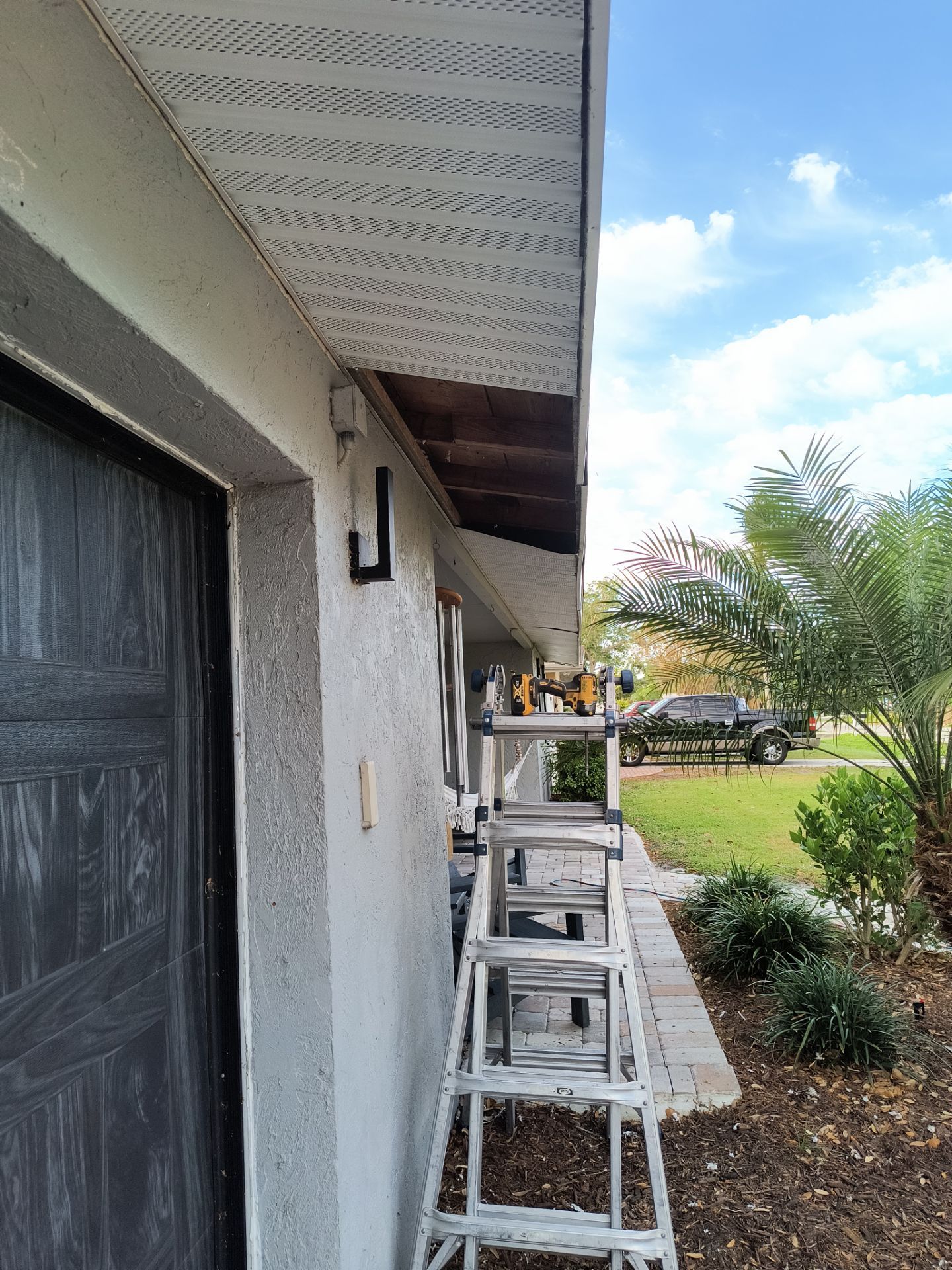 Black Seamless Gutters using 7 inch seamless gutters & New White Soffit in Sarasota FL by Gutter Professors